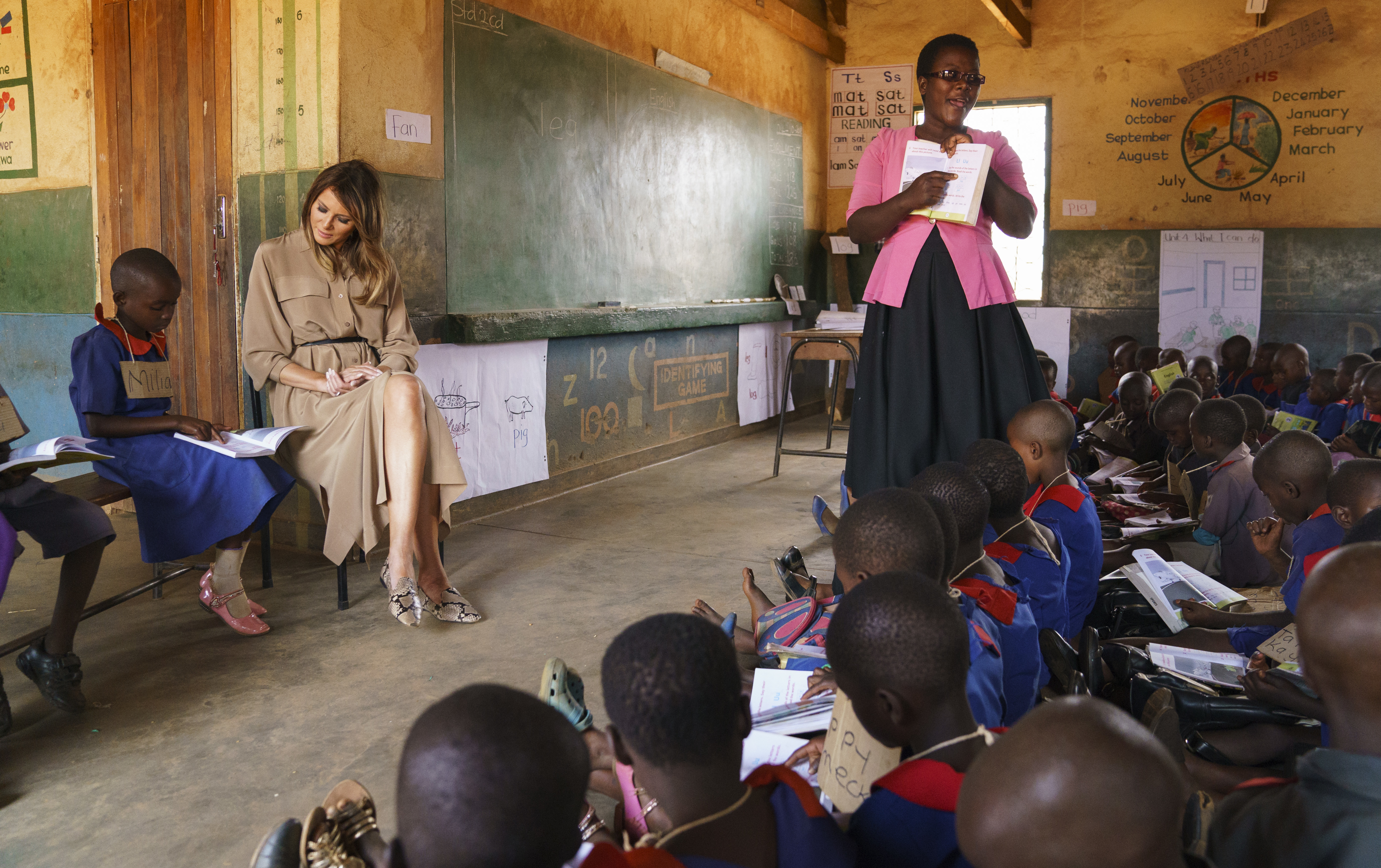 Melania Trump sits with a student during a language class