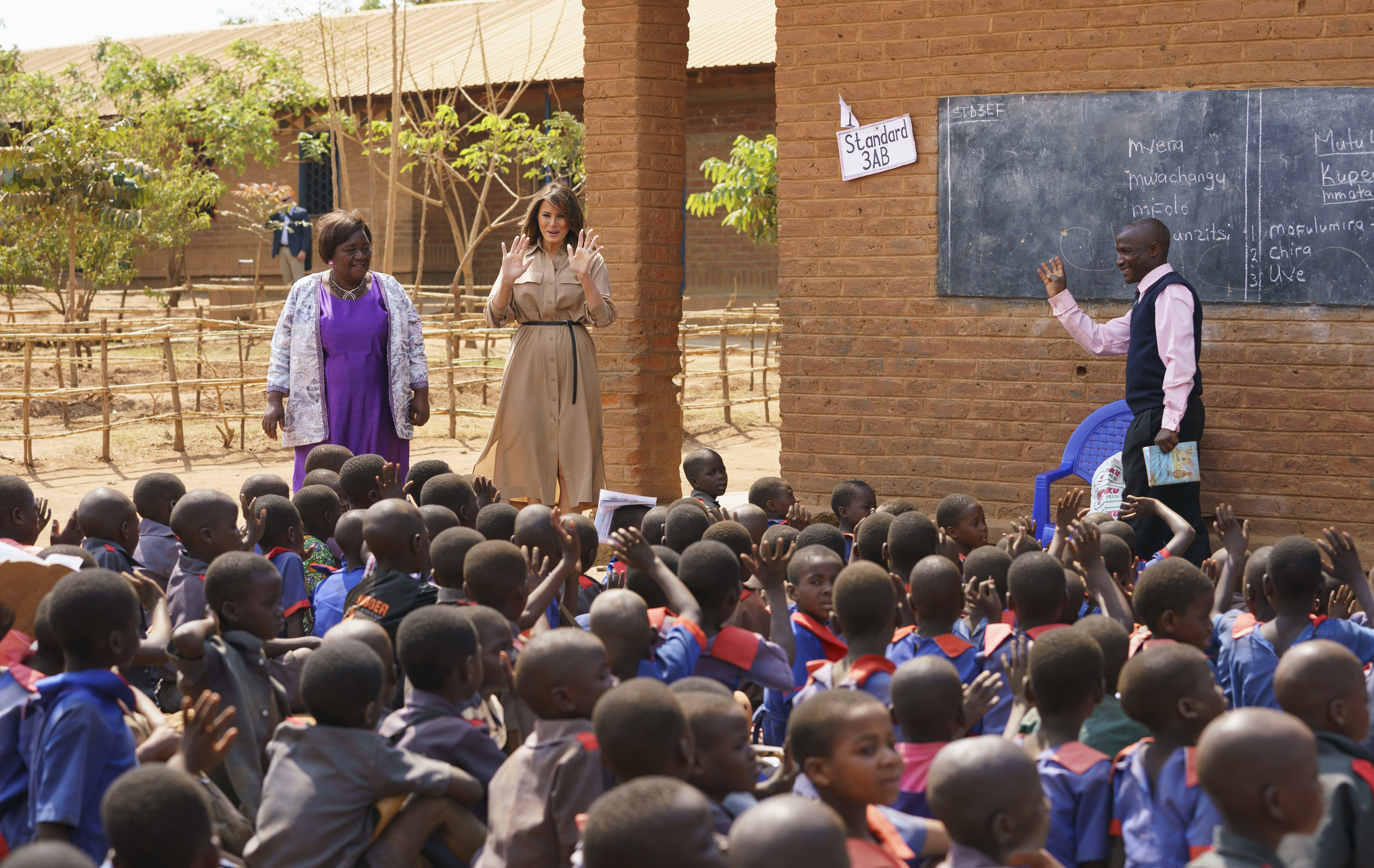 Melania Trump walks with head teacher Maureen Masi to observe an outdoor class at Chipala Primary School 