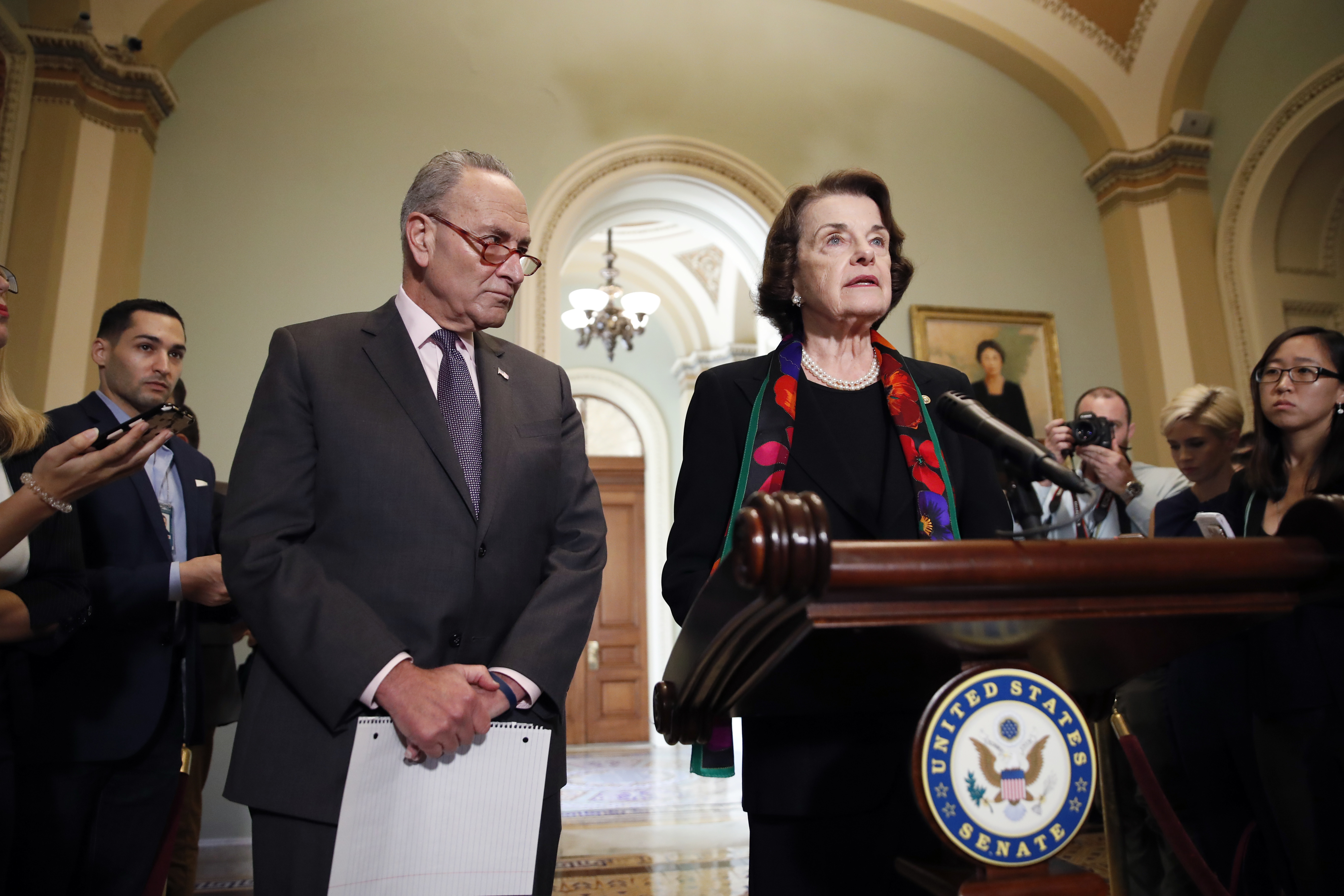 Dianne Feinstein speaks to the media, accompanied by Chuck Schumer