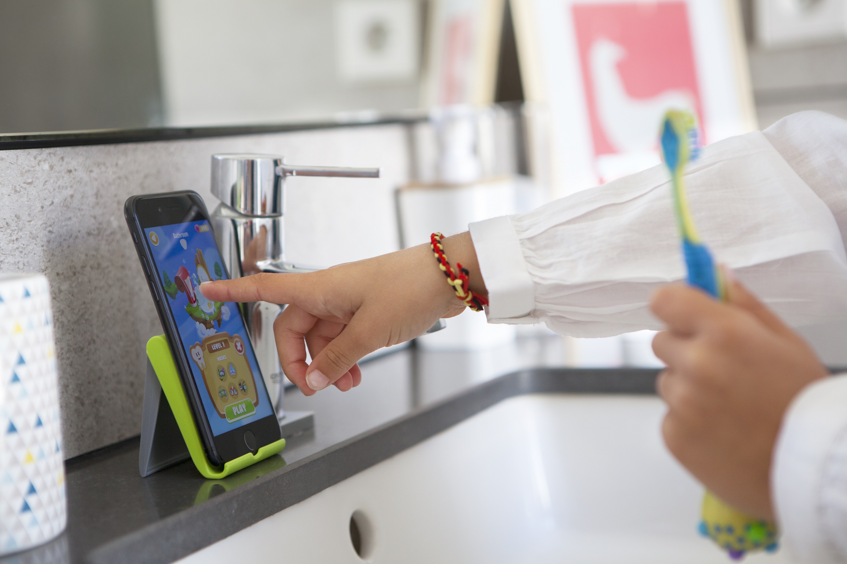 Child touching the screen of a tablet.