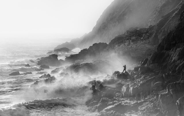 Fisherman on rocks in strong westerly winds, Porth Nanven, Cornwall, was a category winner for Mick Blakey (Mick Blakey/Landscape Photographer of the Year/PA)