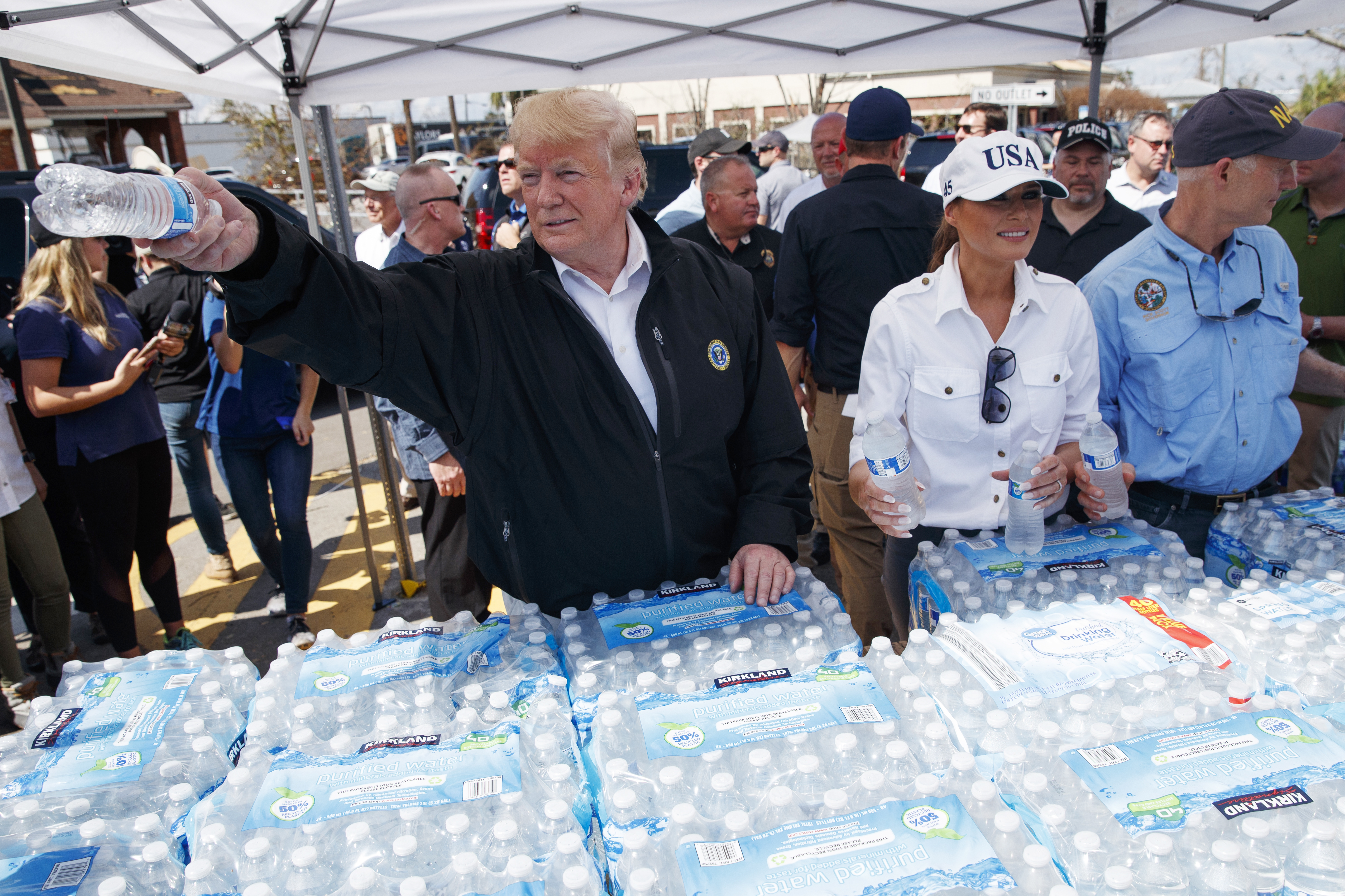 Donald and Melania Trump hand out water during a visit to areas affected by Hurricane Michael in Florida 