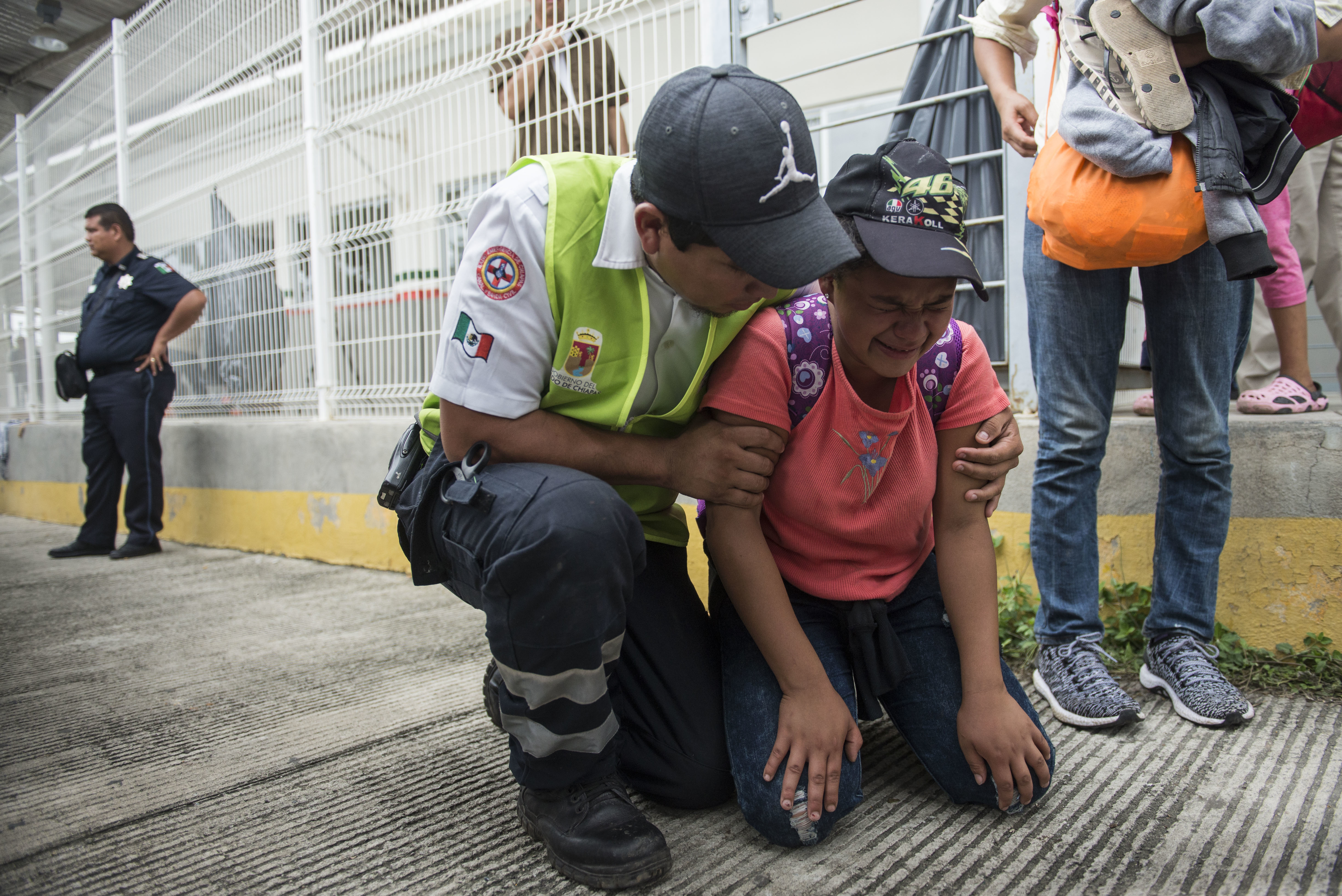 A Honduras migrant is comforted by a Mexican paramedic 