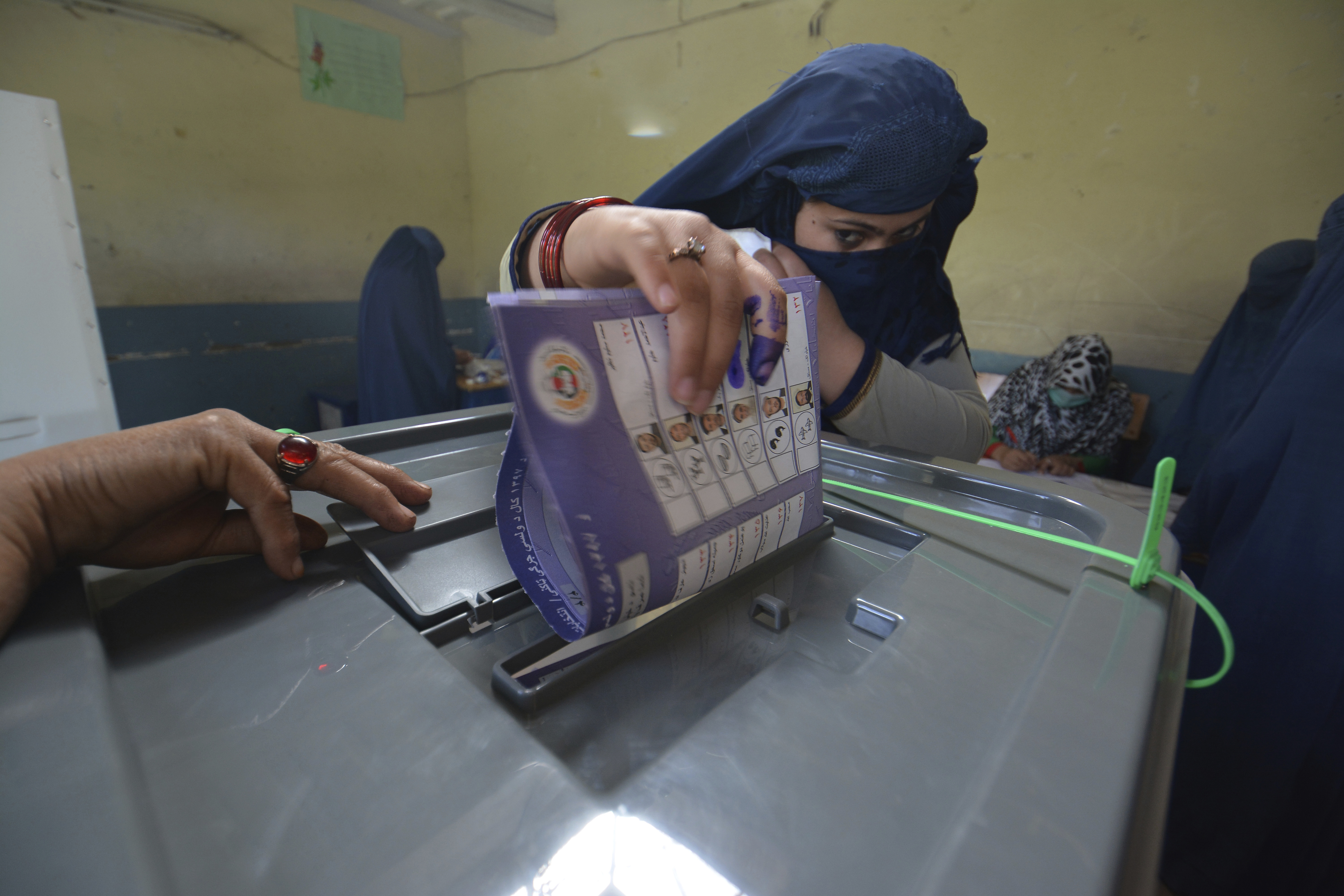 A woman casts her vote in Jalalabad, capital of eastern Nangarhar province, Afghanistan