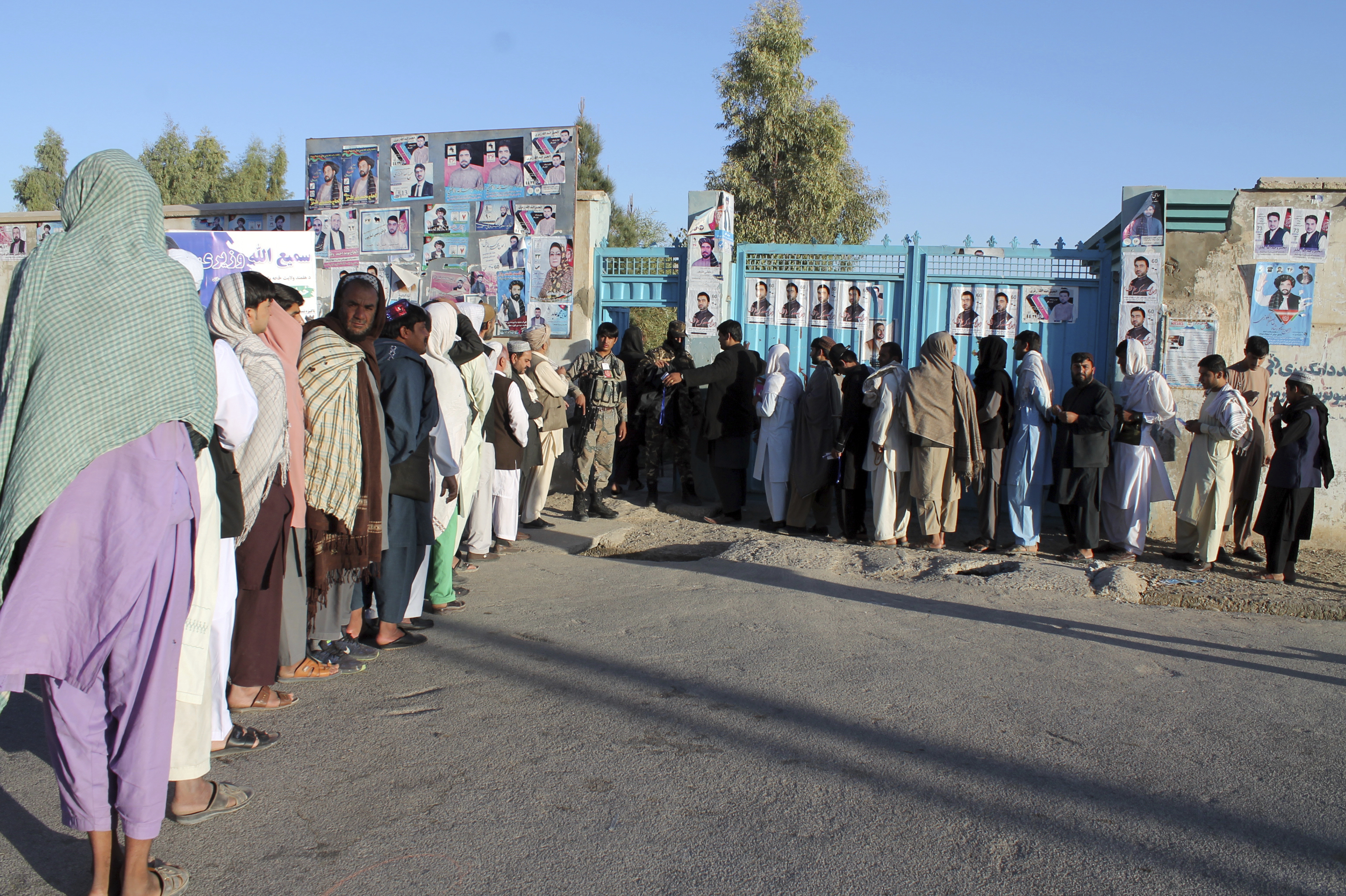 Afghan men line up to cast their votes in Helmand province