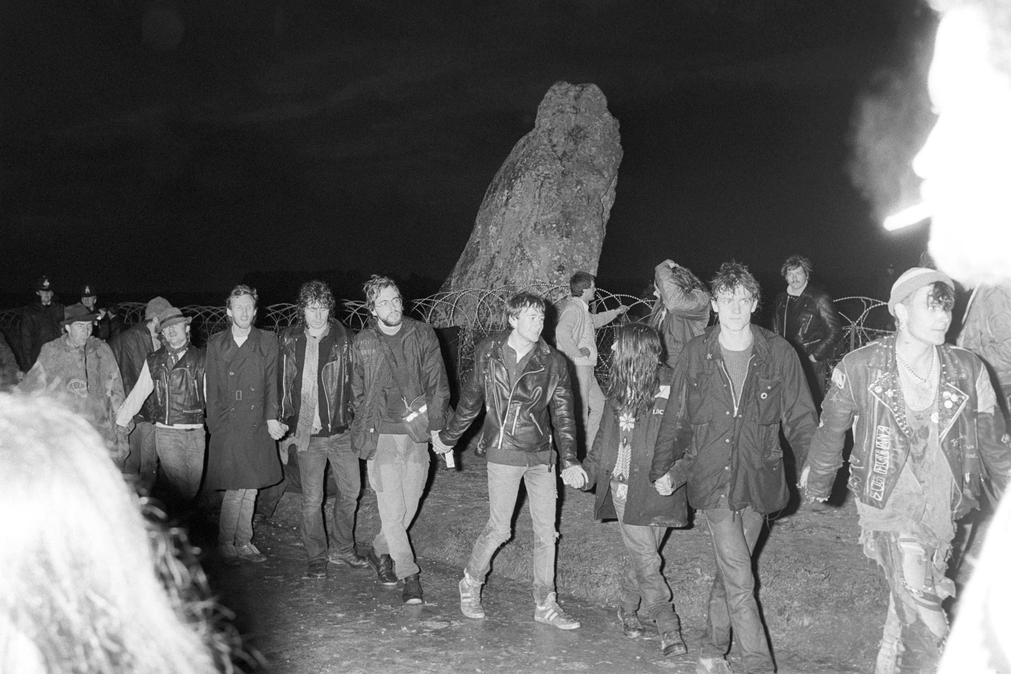 A 1985 photo of people chanting and holding hands ahead of Summer Solstice celebrations at Stonehenge
