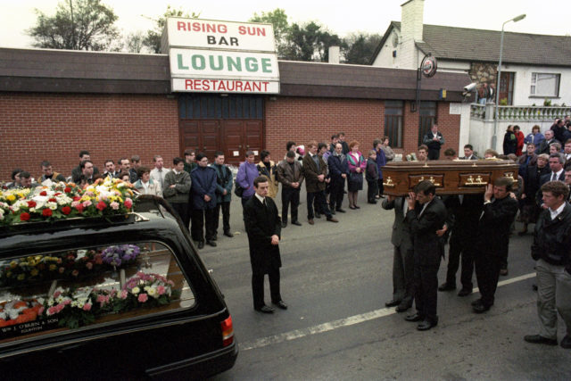 Steven Mullan's coffin passes the Rising Sun bar in Greysteel 