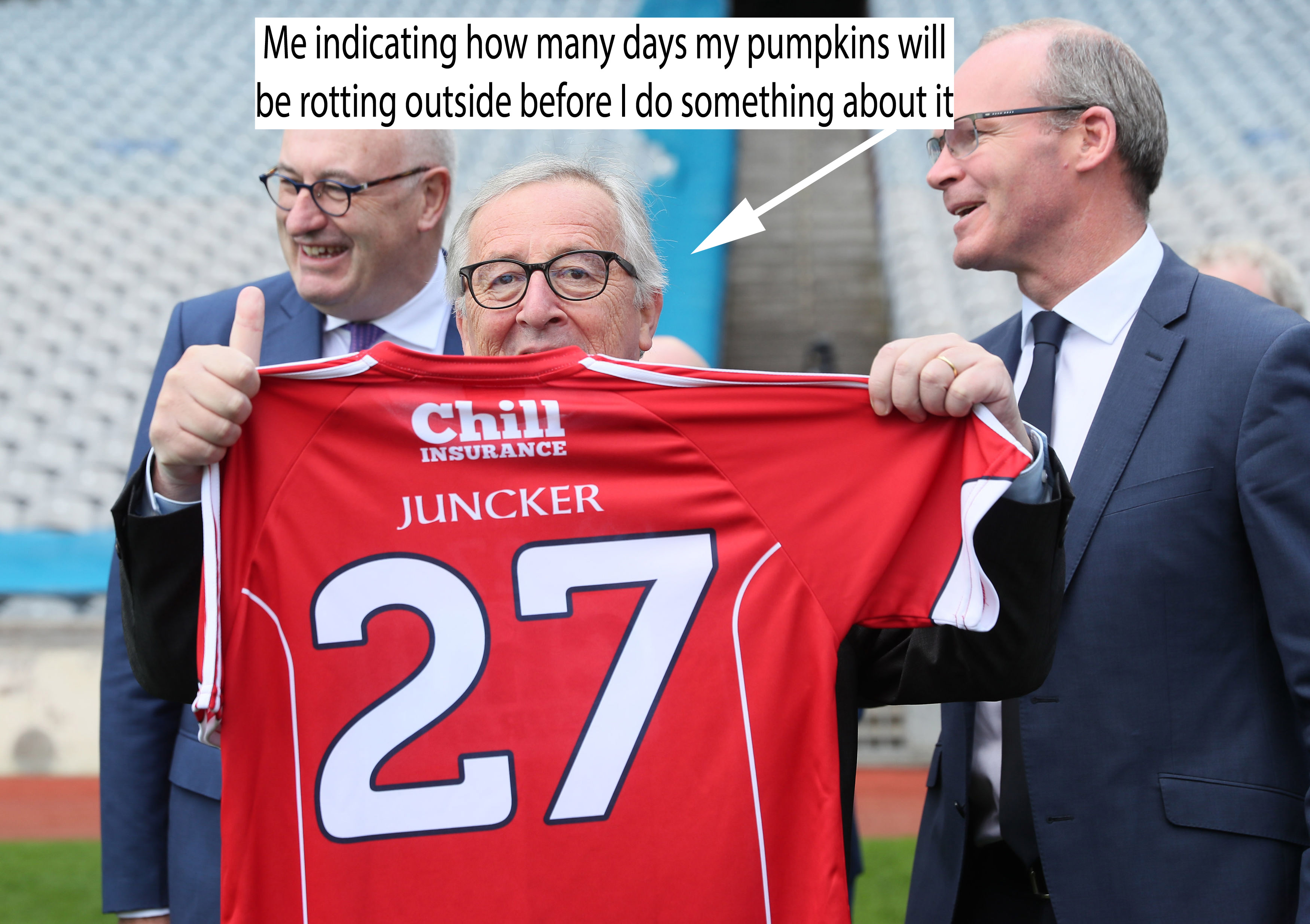 Juncker holding up a shirt reading 27