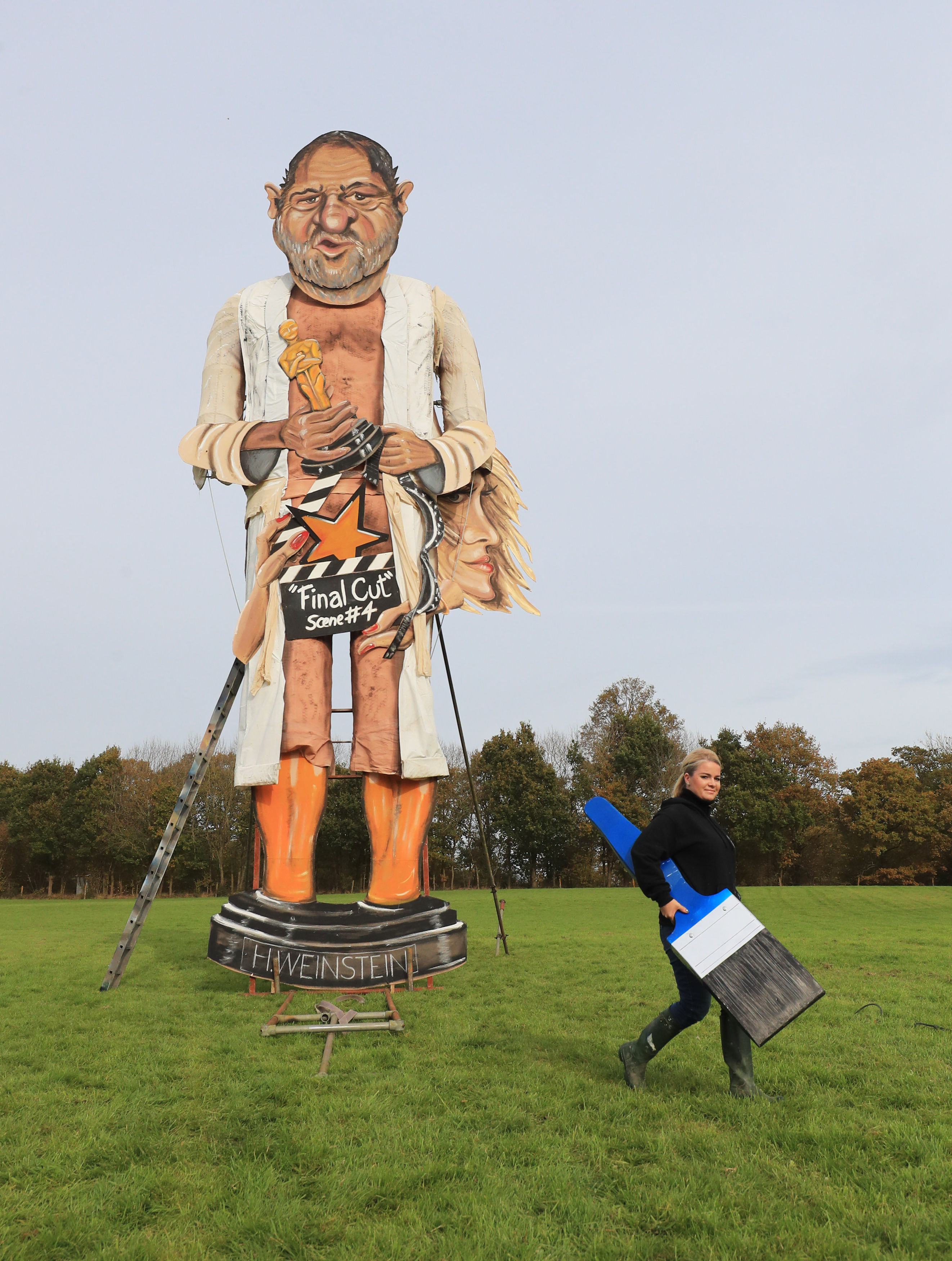 Artist Andrea Deans after putting the finishing touches to the Edenbridge Bonfire Society celebrity guy which has been unveiled as Harvey Weinstein in Edenbridge, Kent 