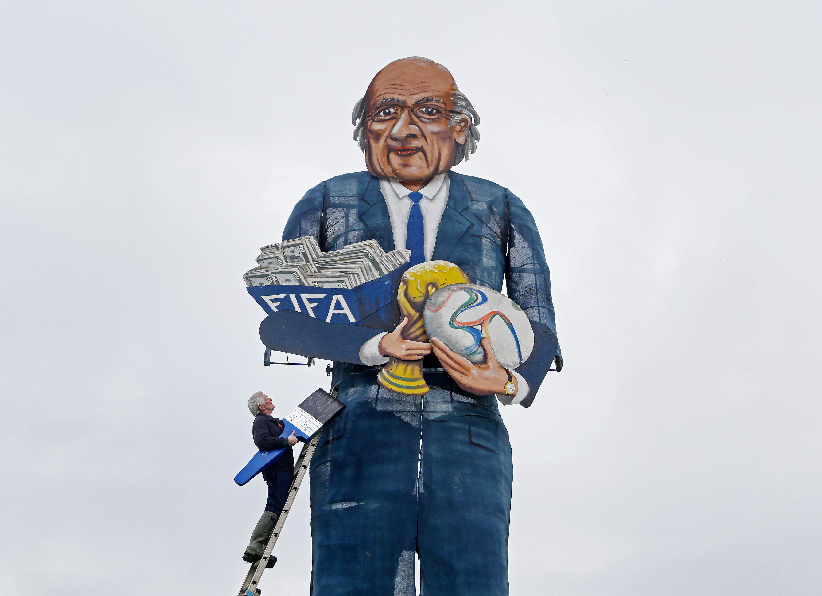 Artist Frank Shepherd puts the final touches to the Edenbridge Bonfire Society celebrity guy which has been unveiled as FIFA president Sepp Blatter, in Edenbridge, Kent, in 2015
