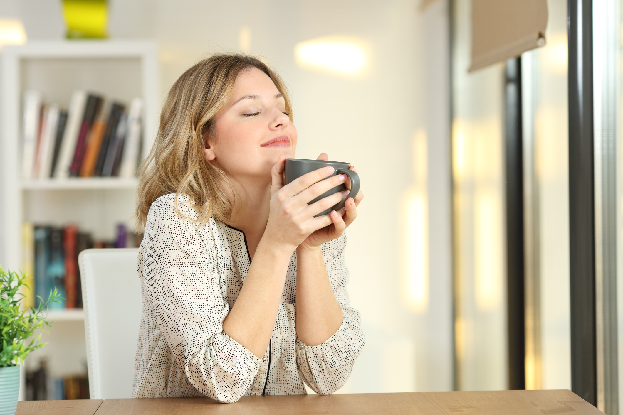Woman breathing holding a coffee mug at home