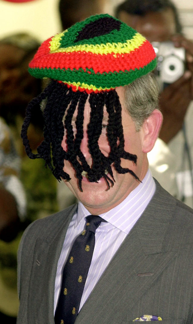 The Prince of Wales laughing with the local Rasta community, as he wears a Rasta hat, at the Trenchtown community centre in Kingston, Jamaica, during his tour of the Caribbean (John Stillwell/PA)