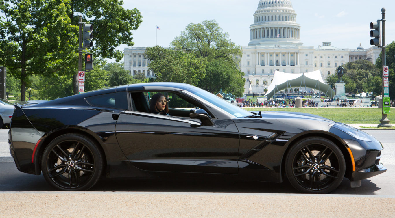 Black Widow behind the wheel of her Corvette.