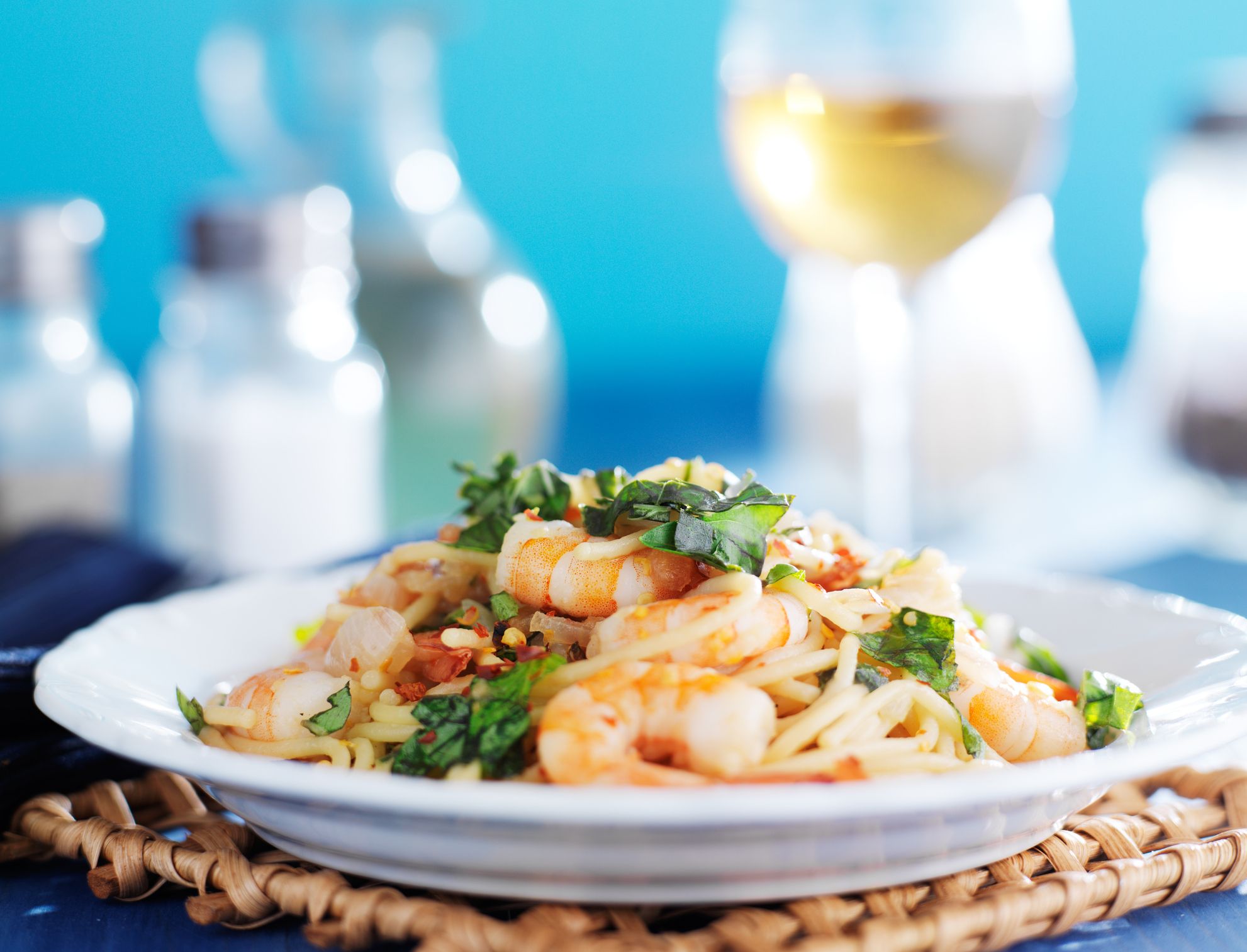 Sicilian spaghetti with white wine in background