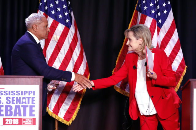 Cindy Hyde-Smith and Mike Espy shake hands following their televised debate