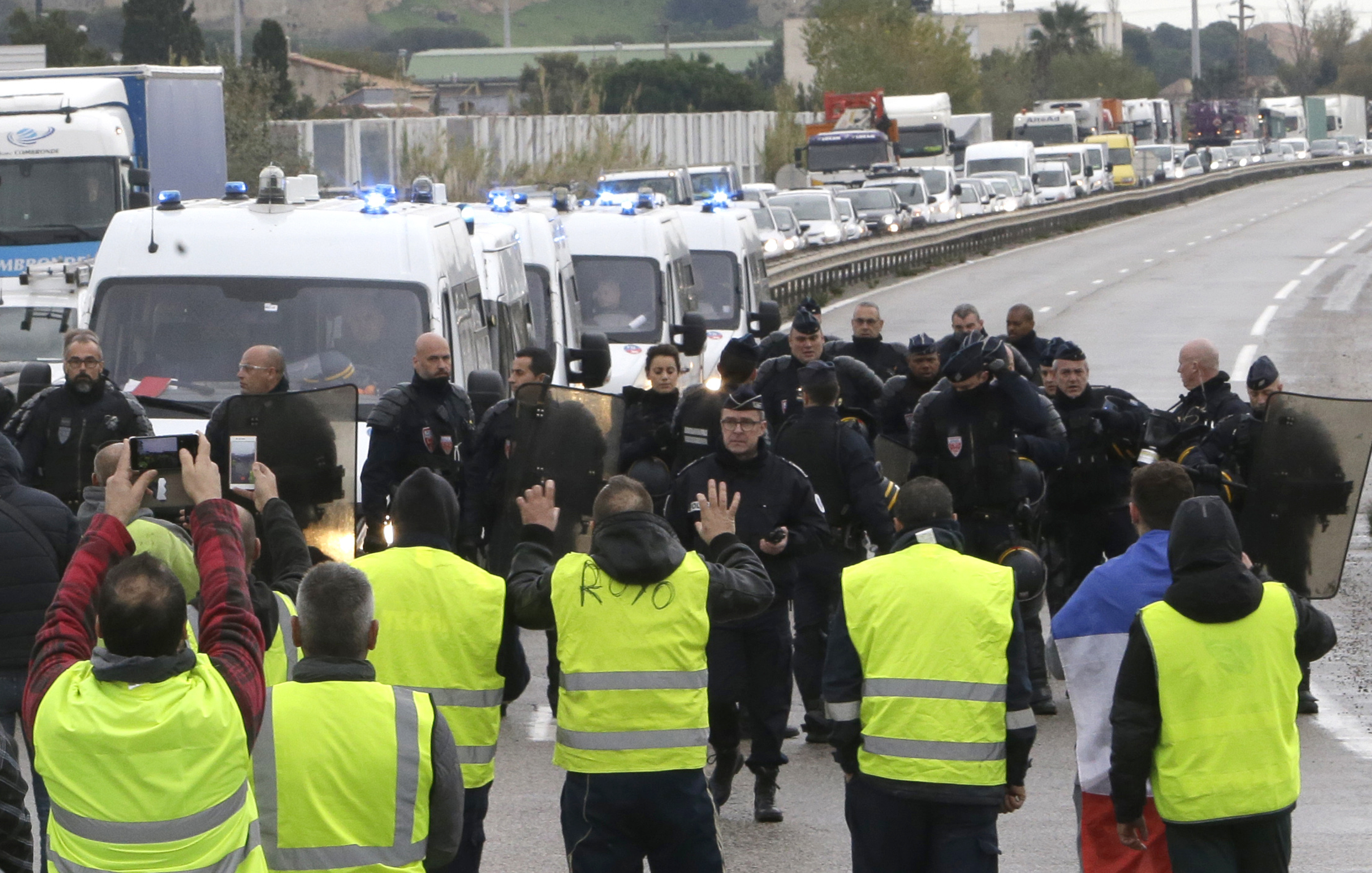 Protesters face riot police officers