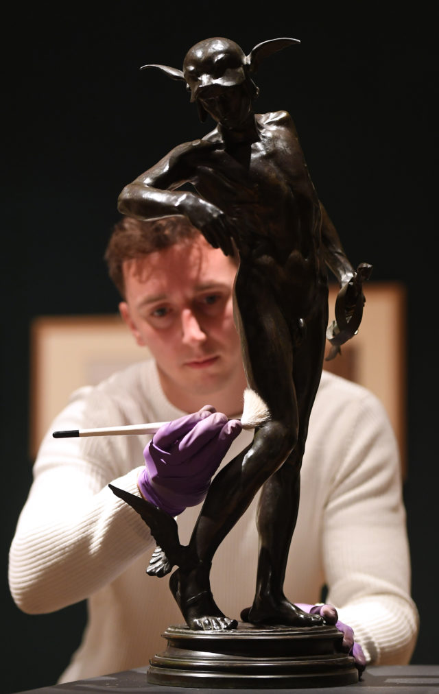 Gallery technician Tim Matthews dusts a bronze statue of Greek hero Perseus by Sir Alfred Gilbert. (Joe Giddens/ PA)