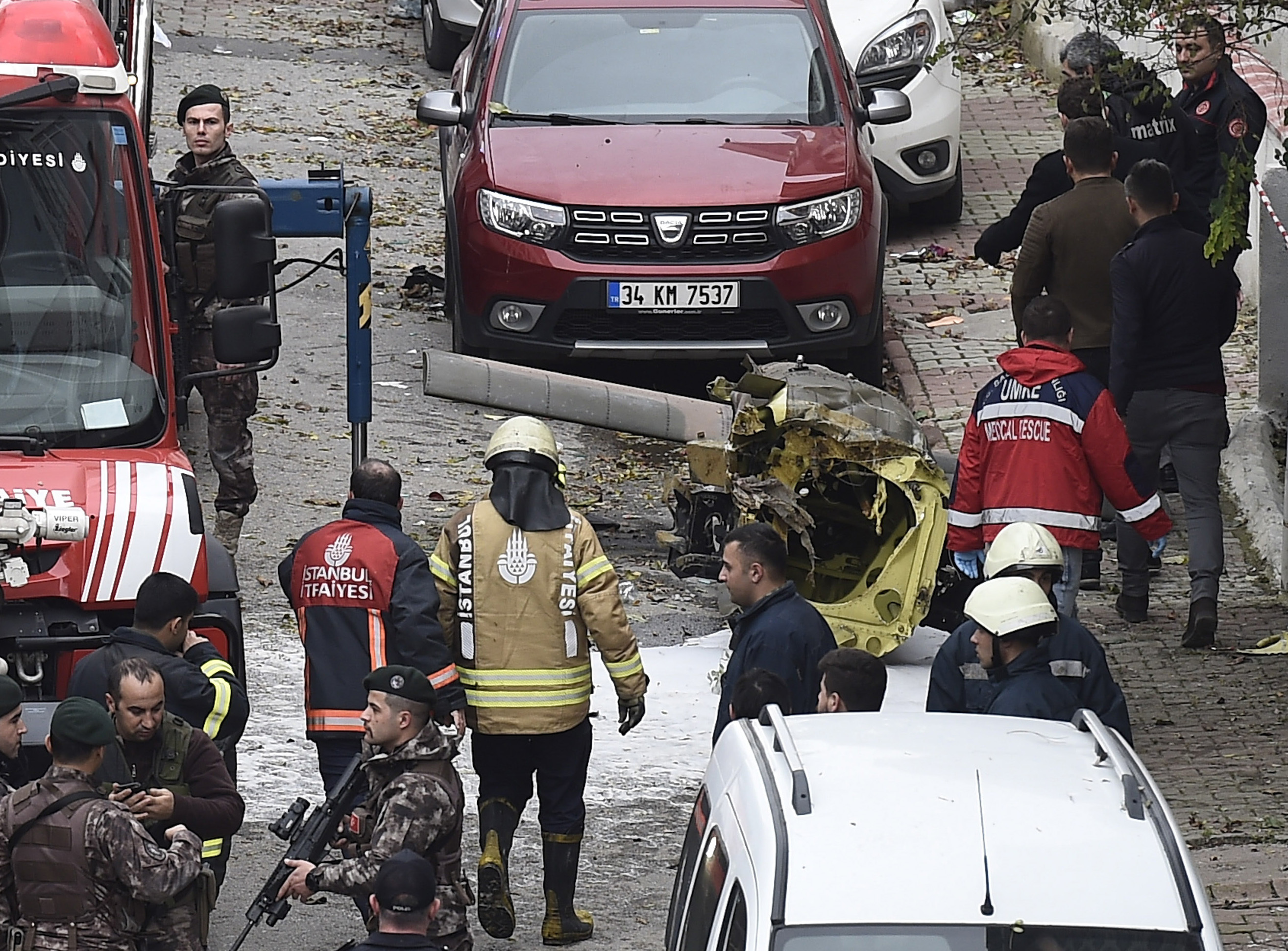 The debris of a military helicopter which crashed with five soldiers on board is seen on the ground in an Istanbul neighbourhood