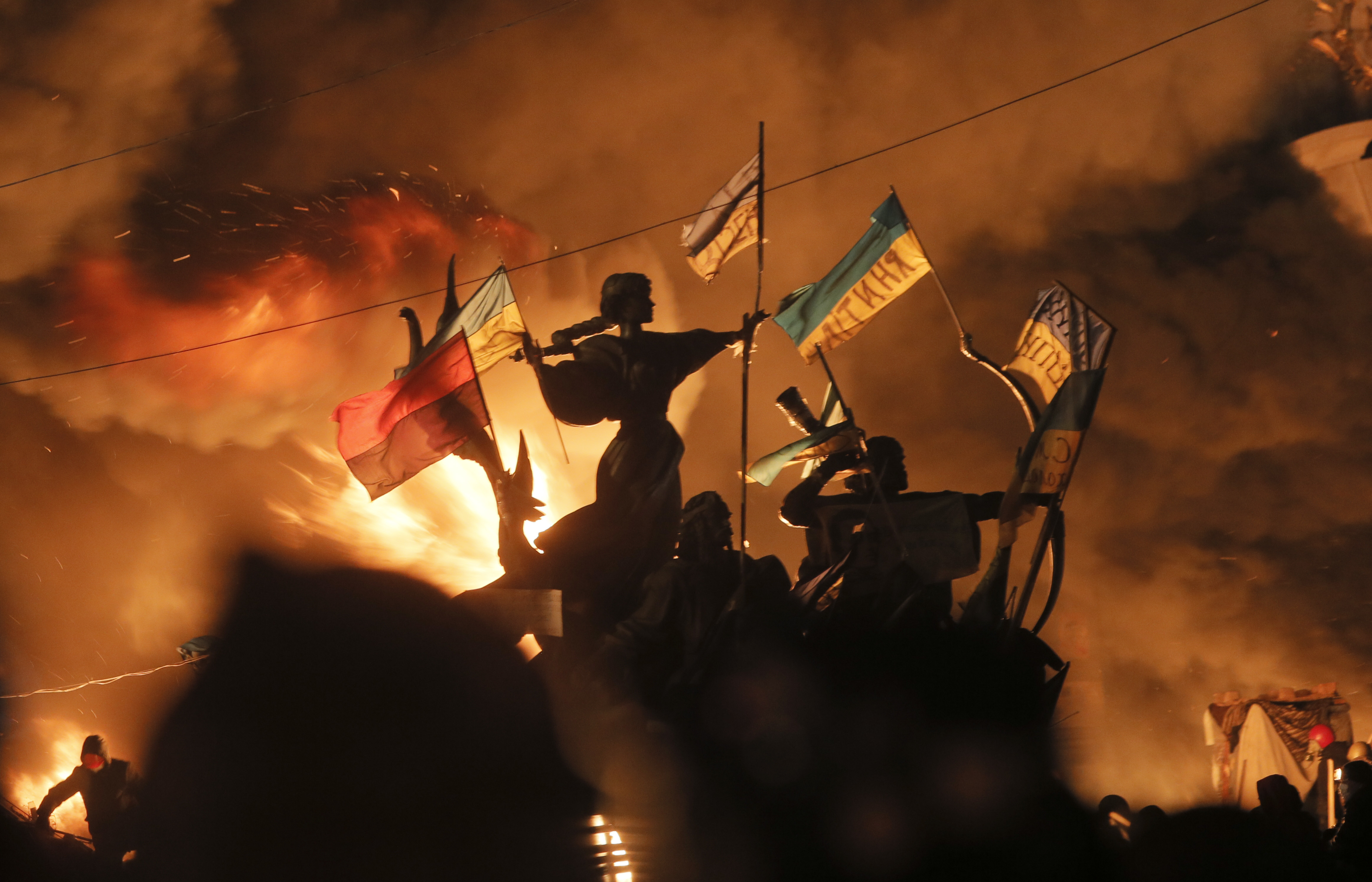 Monuments to Kiev's founders burn as anti-government protesters clash with riot police in Kiev's Independence Square in 2014