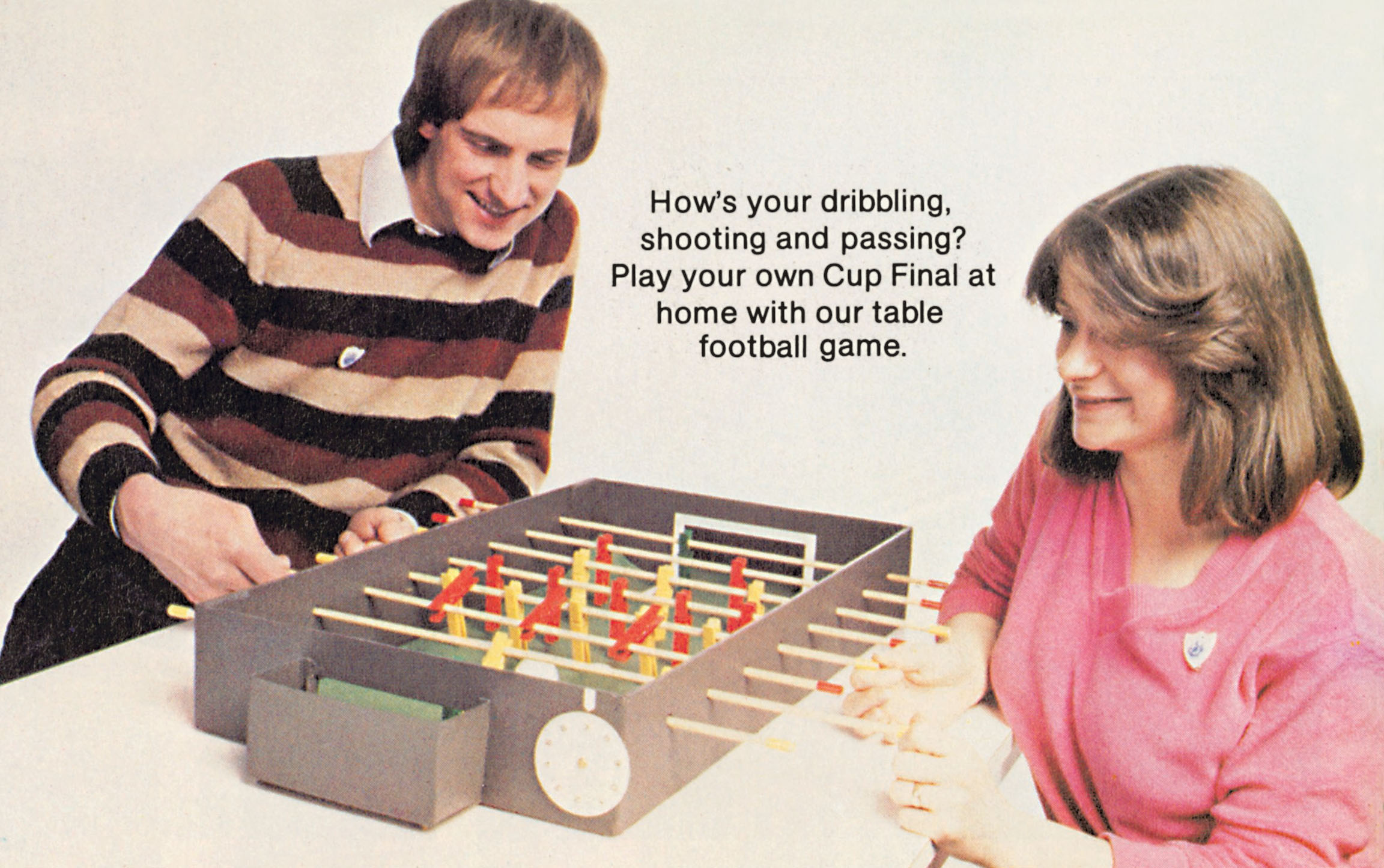 A man and a woman play table football together