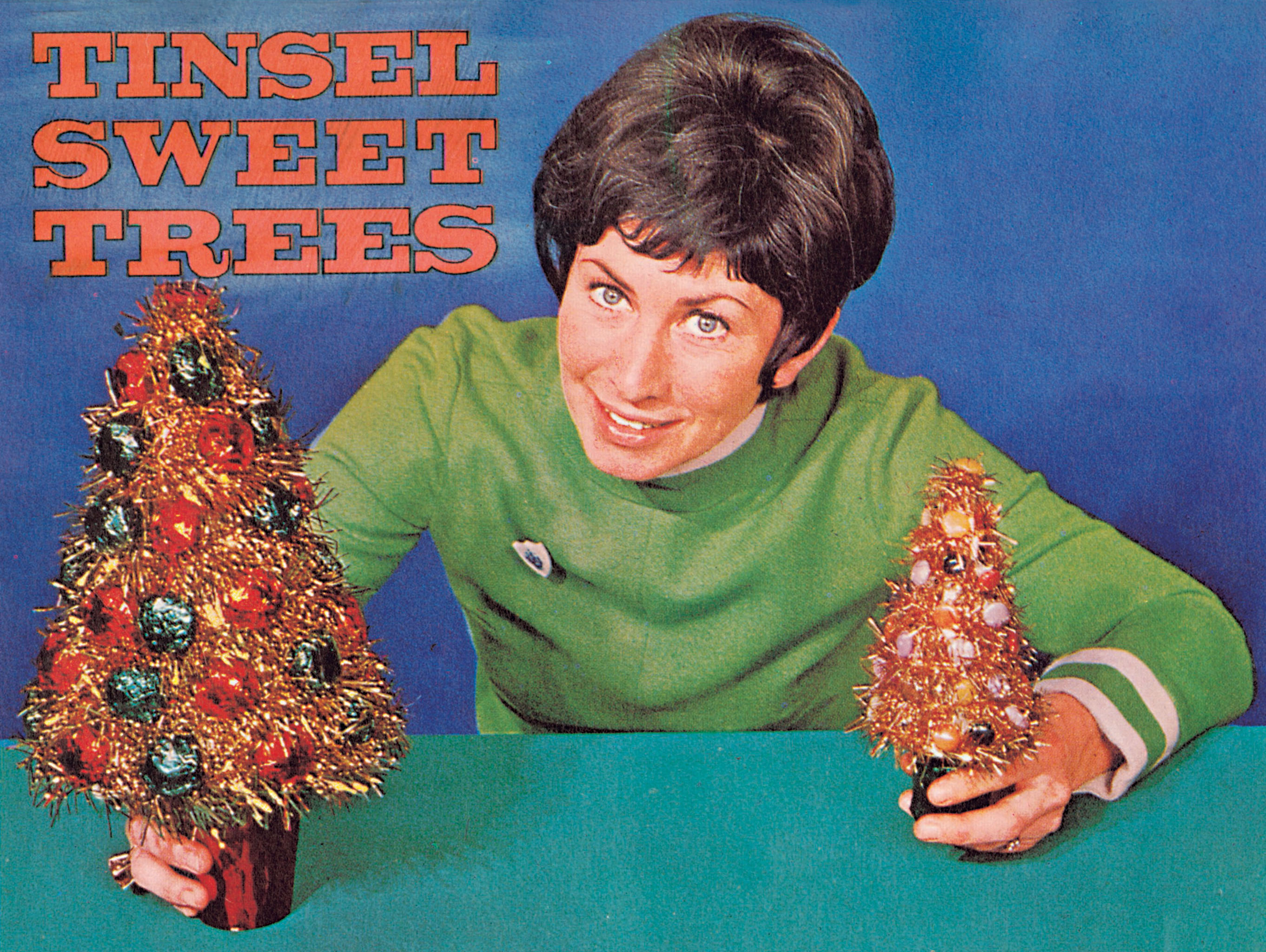 A presenter holds up a homemade Christmas tree
