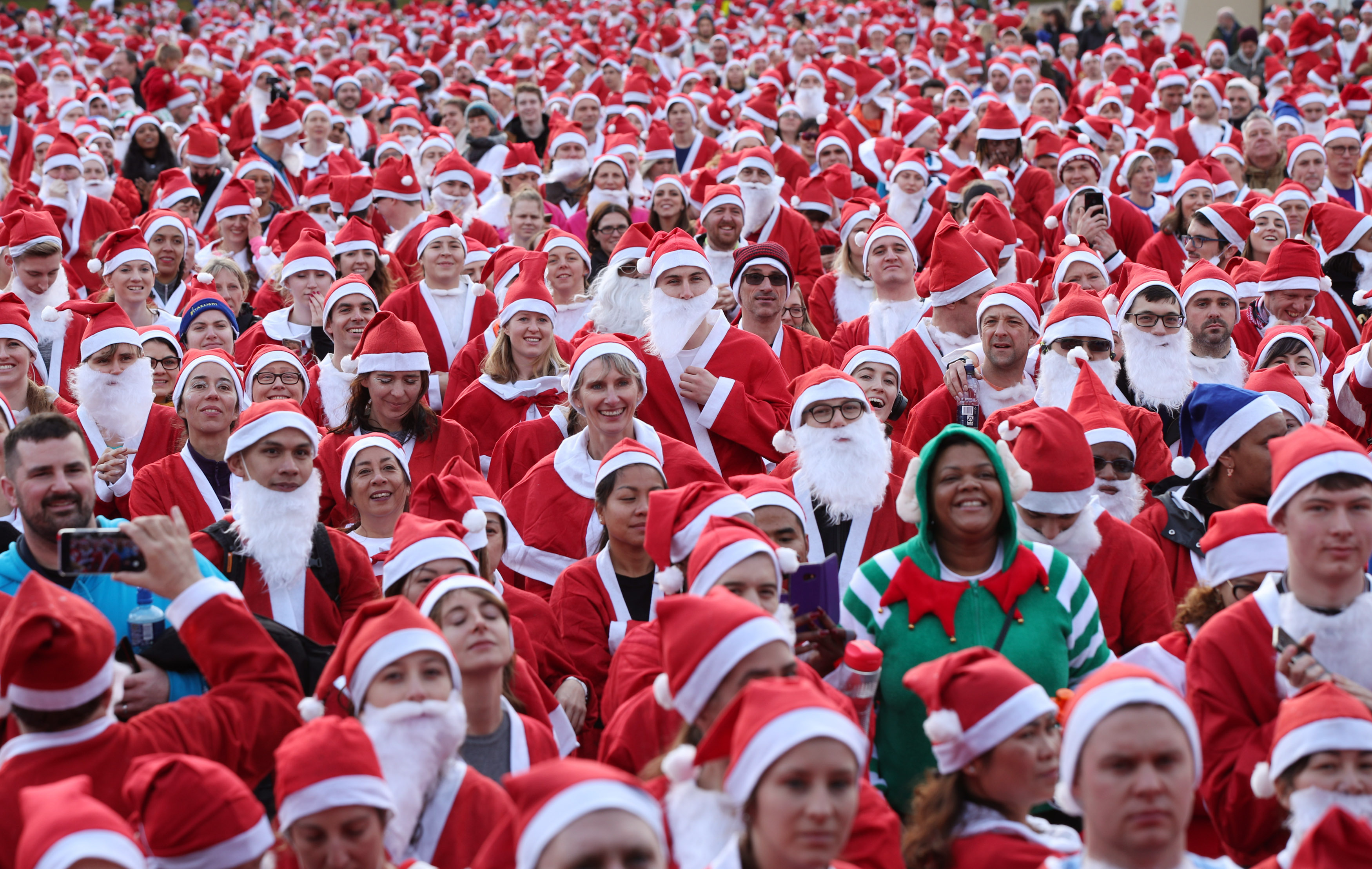 Participants taking part in the London Santa Run in Victoria Park, east London