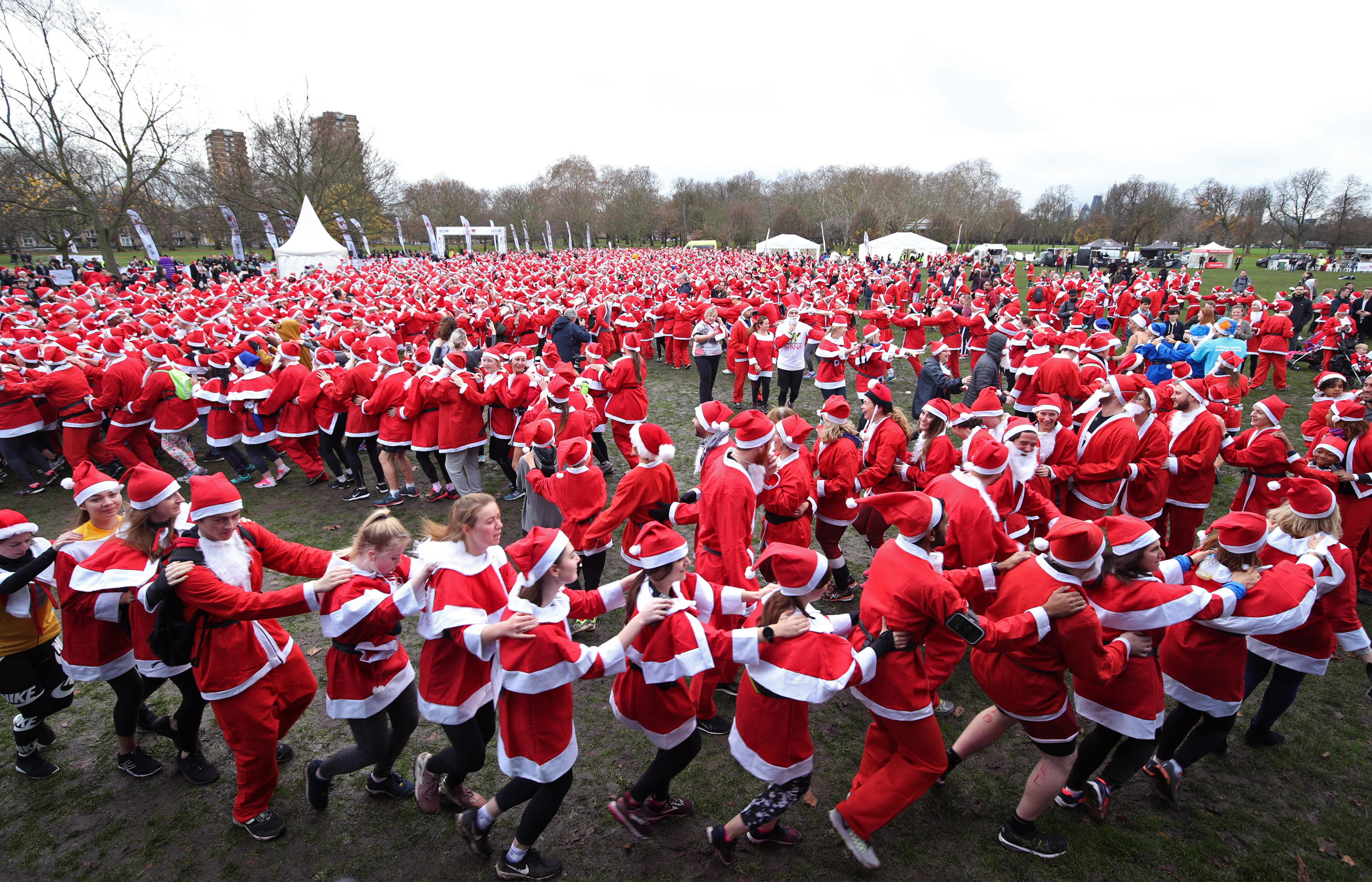 Participants taking part in the London Santa Run in Victoria Park, east London