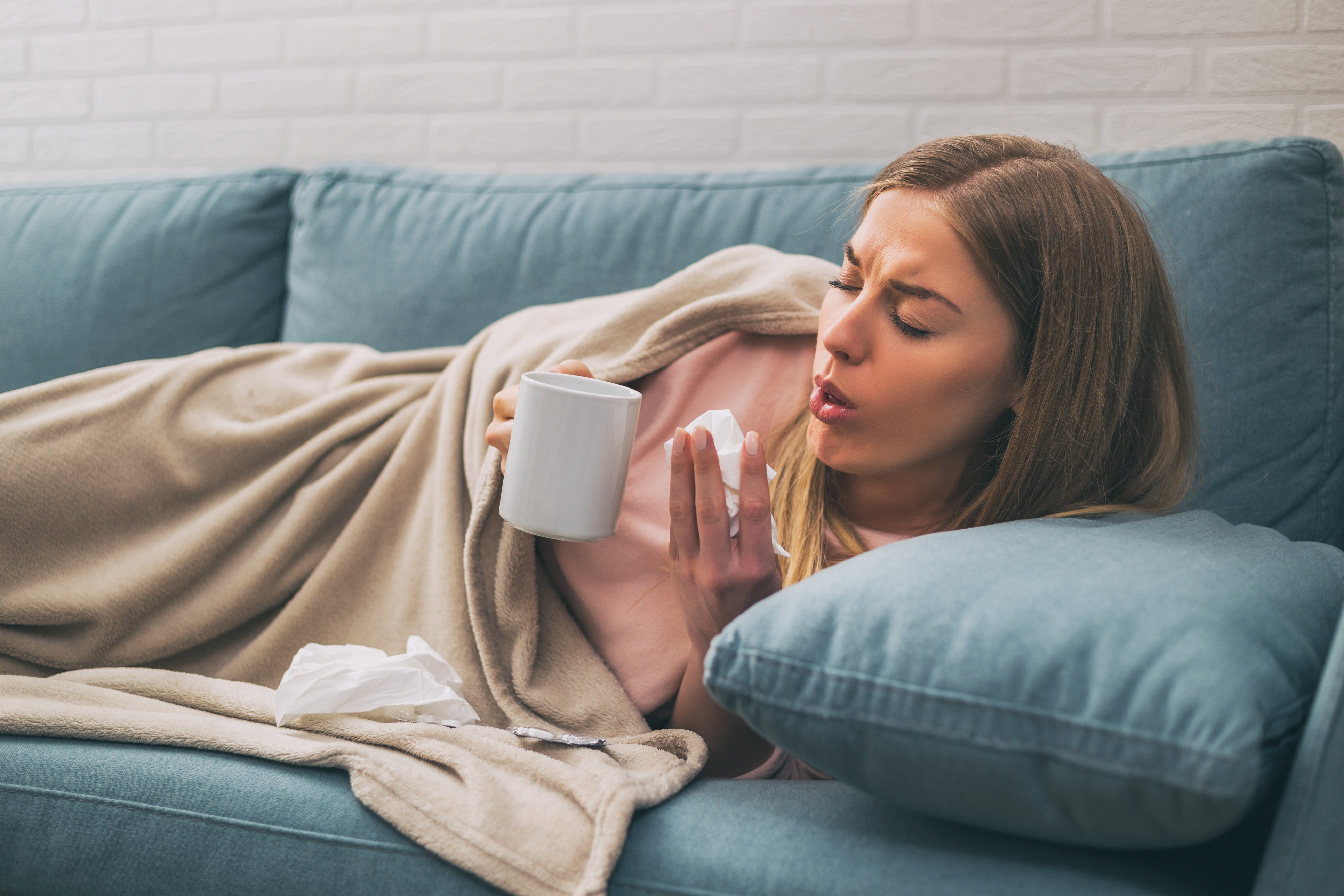 Ill woman lying on the sofa