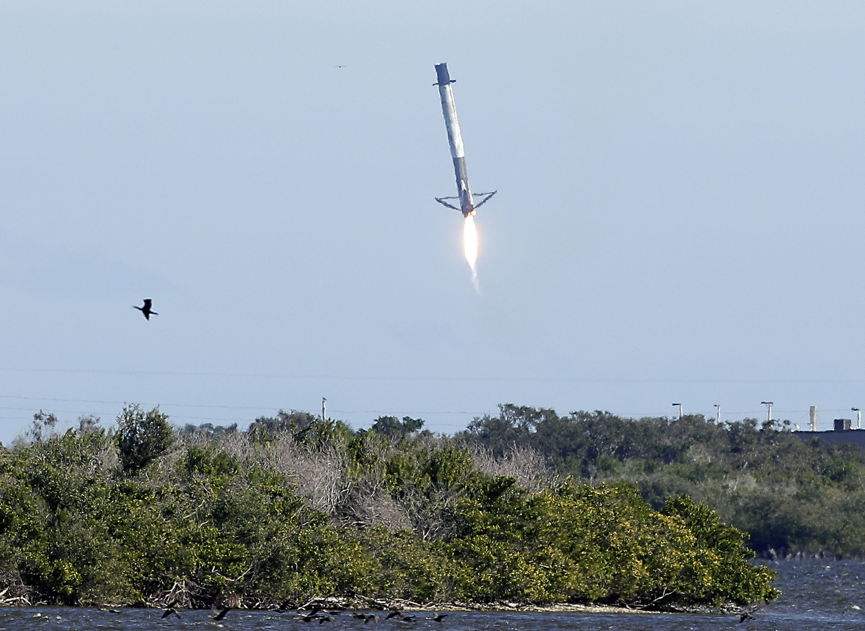 The first-stage booster from a Falcon 9 rocket experiences a control problem during its descent, landing in the Atlantic Ocean just east of the launch site instead of a landing zone at the Cape Canaveral Air Force Station