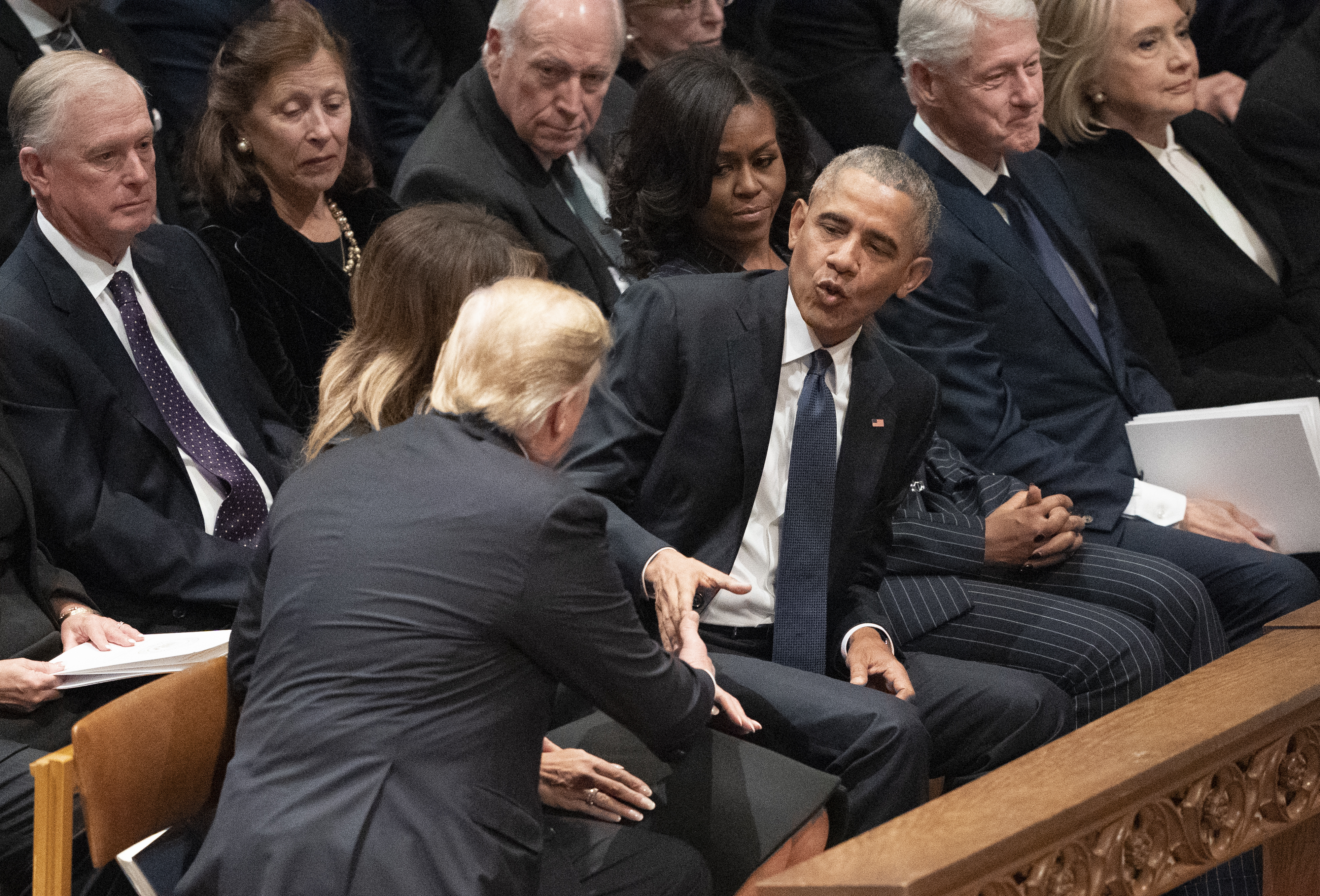 President Donald Trump shakes hands with former president Barack Obama during a state funeral service for former president George HW Bush