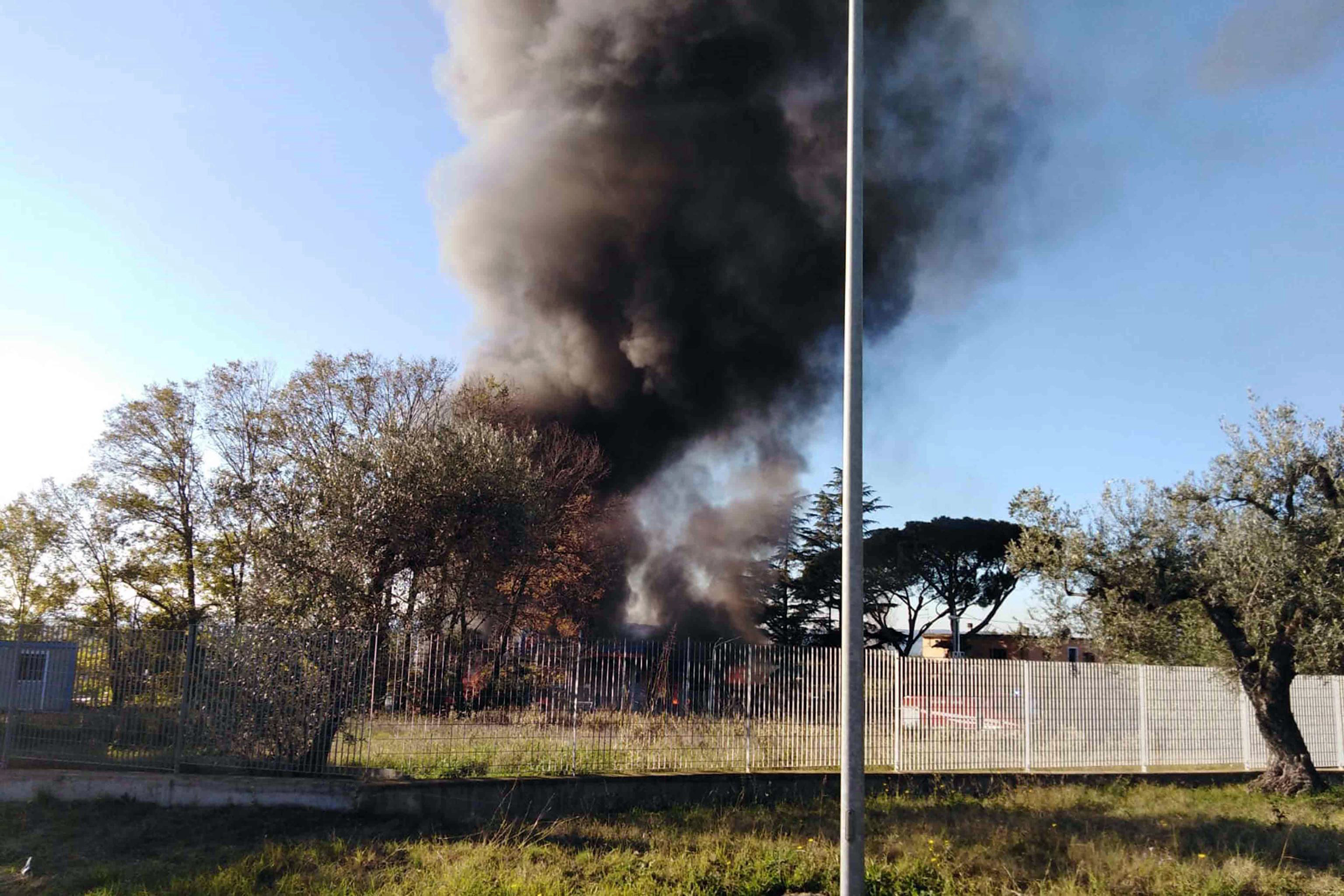 Smoke billows in the area where an explosion occurred at a petrol station in Borgo Quinzio, near Rieti, Italy