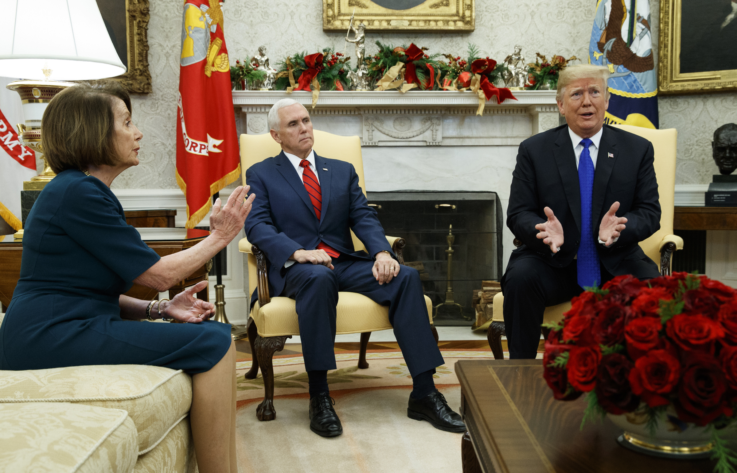 Vice President Mike Pence, center, looks on as House Minority Leader Rep. Nancy Pelosi, D-Calif., and President Donald Trump speak during a meeting in the Oval Office of the White House