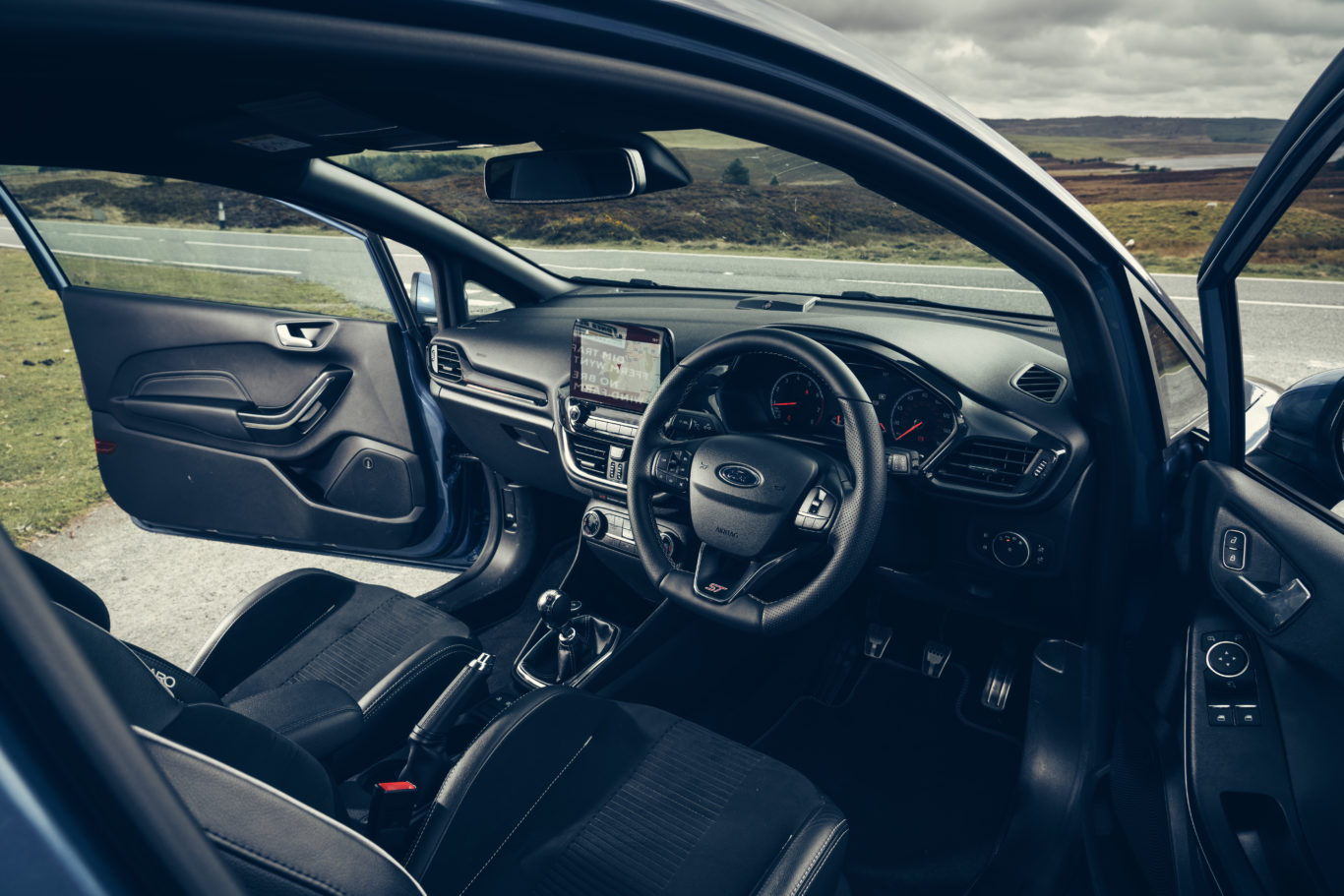 The interior features heavily bolstered sports seats