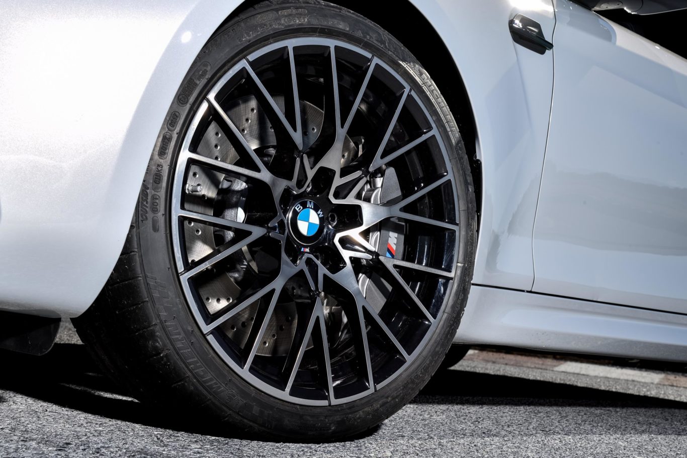 Large alloy wheels sit in front of M-spec brakes