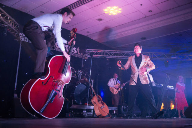 Mark Summer performing as Elvis with a band