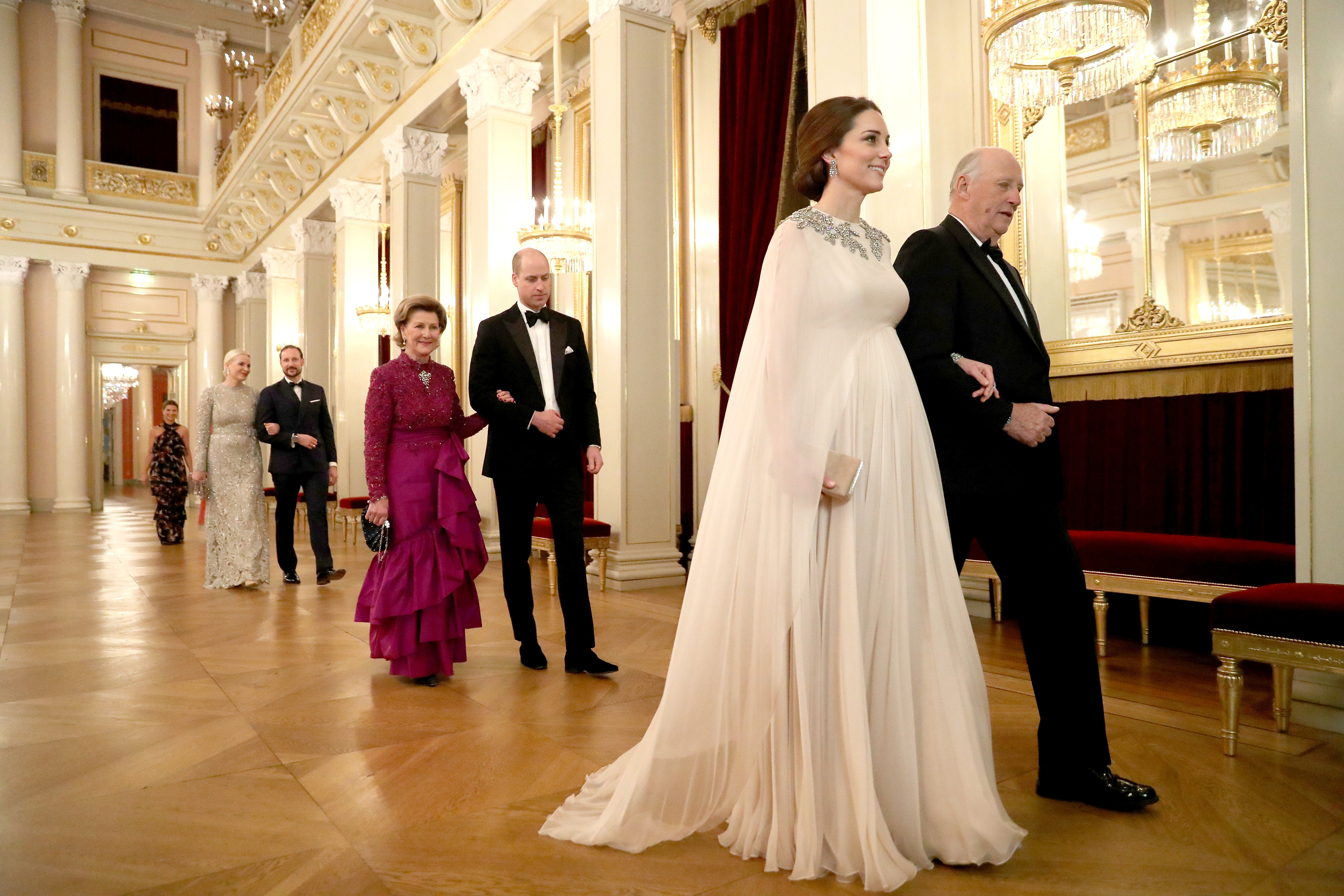 The Duchess of Cambridge is escorted into dinner by King Harald V of Norway