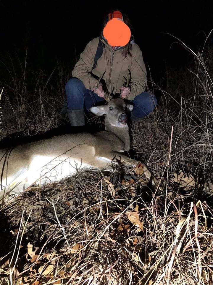 A poacher shows off a slain deer