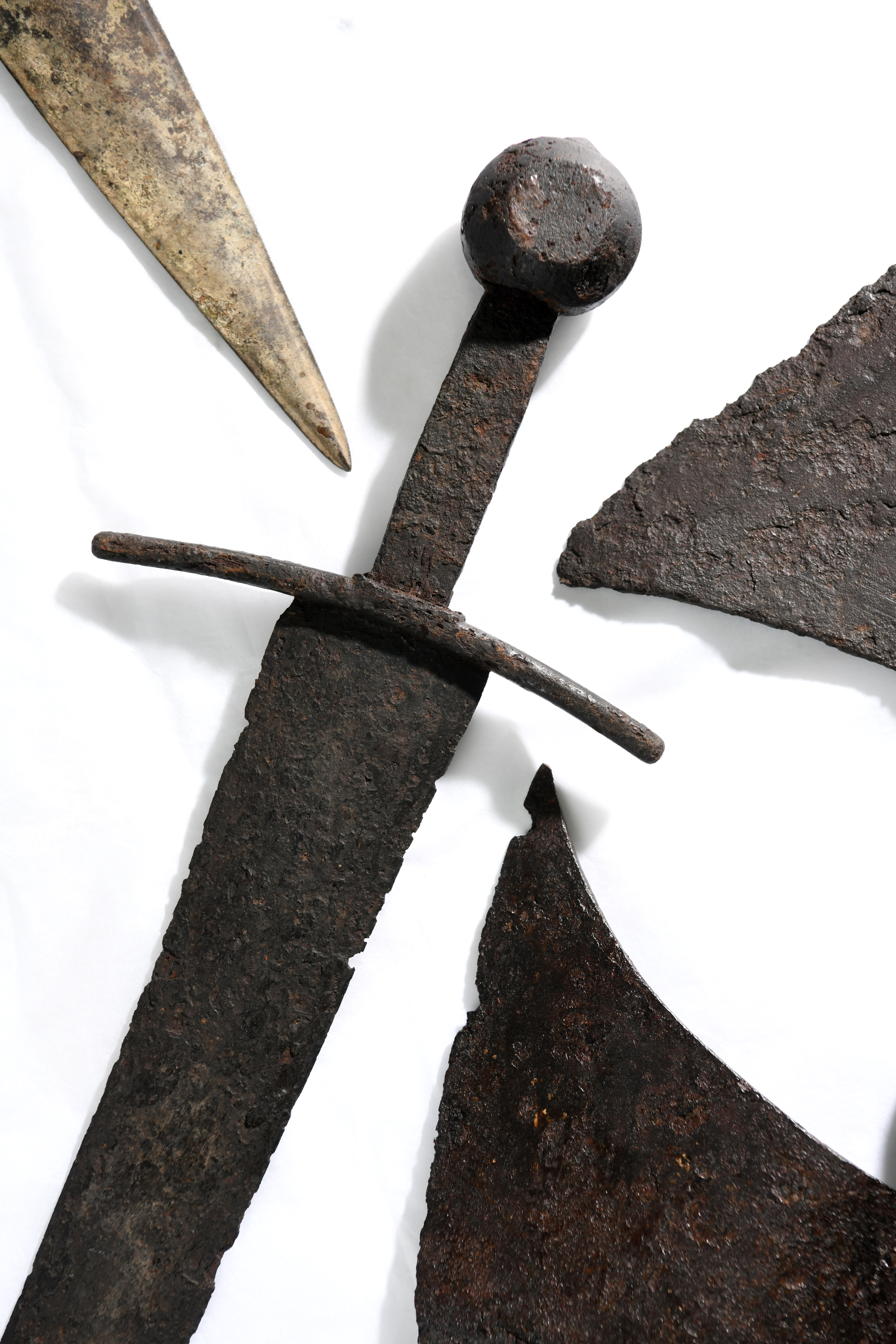 A 14th Century sword, surrounded by other artefacts, before they go on display