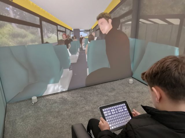 A child uses an iPad to navigate a scenario aimed at overcoming a fear of using public transport (Third Eye NeuroTech and Newcastle University/PA)