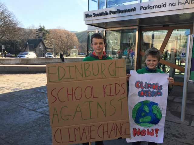 Adam Ballard, 12, and Lucas Ballard, 9, at a climate change protest outside the Scottish Parliament in Edinburgh