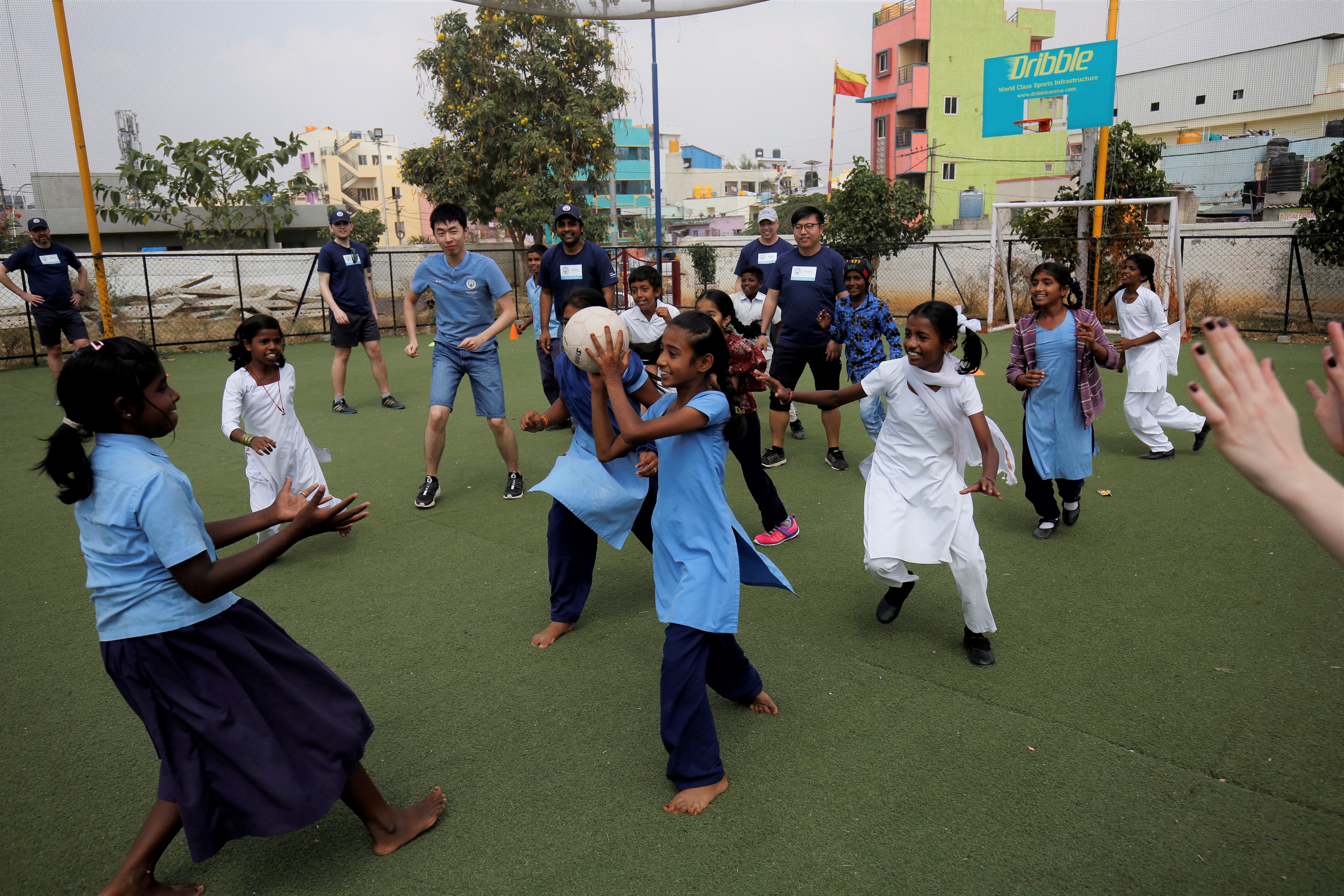 Football coaches playing games with the children