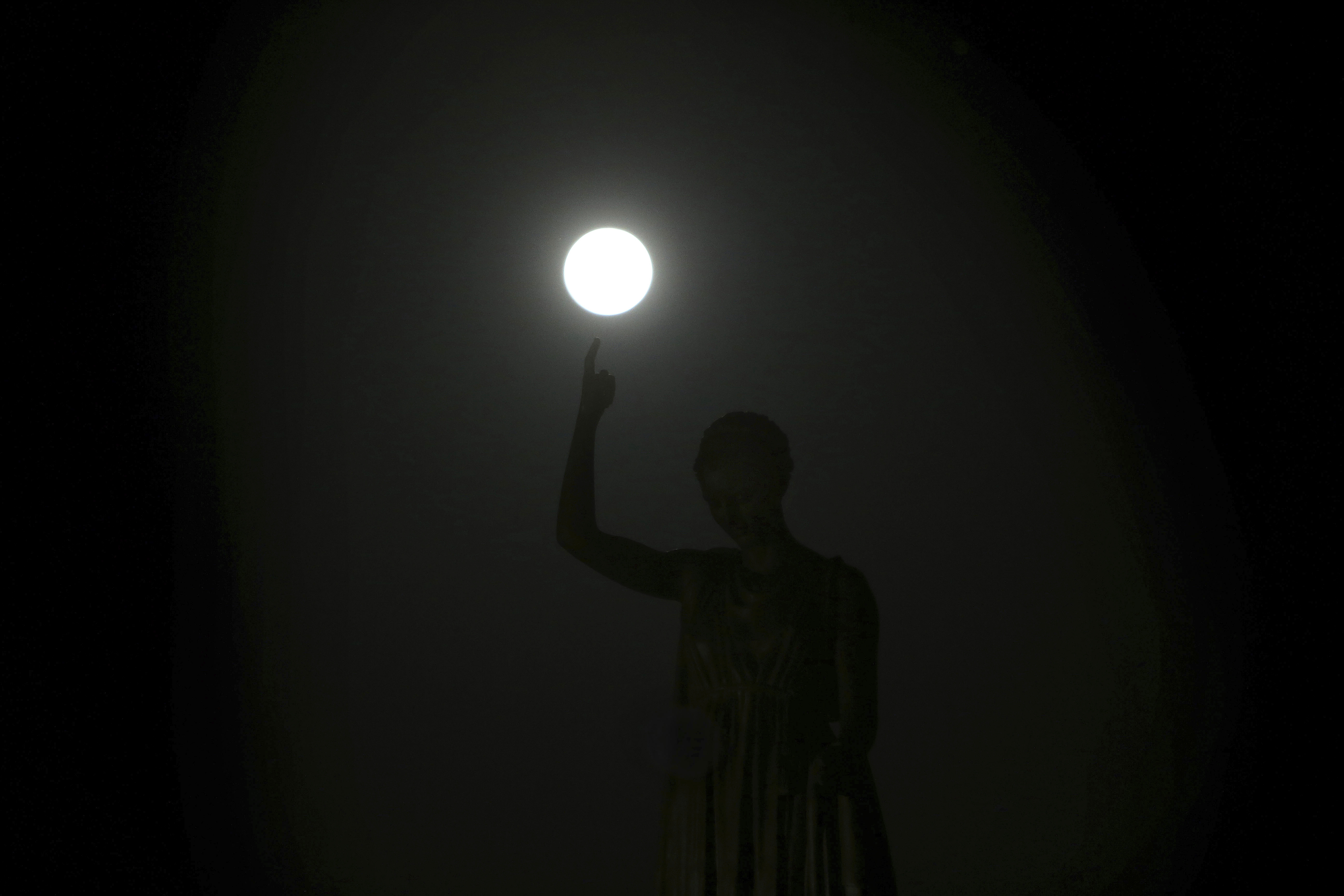 The supermoon rises over the Liberty Monument in Nicosia, Cyprus