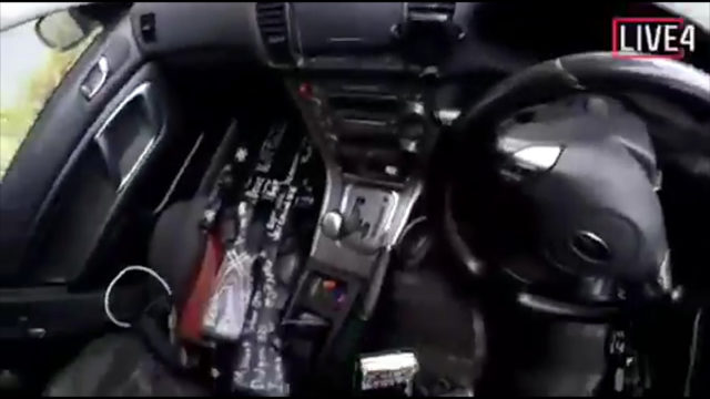 An image from the alleged shooter's video, showing three guns on the passenger seat of a car