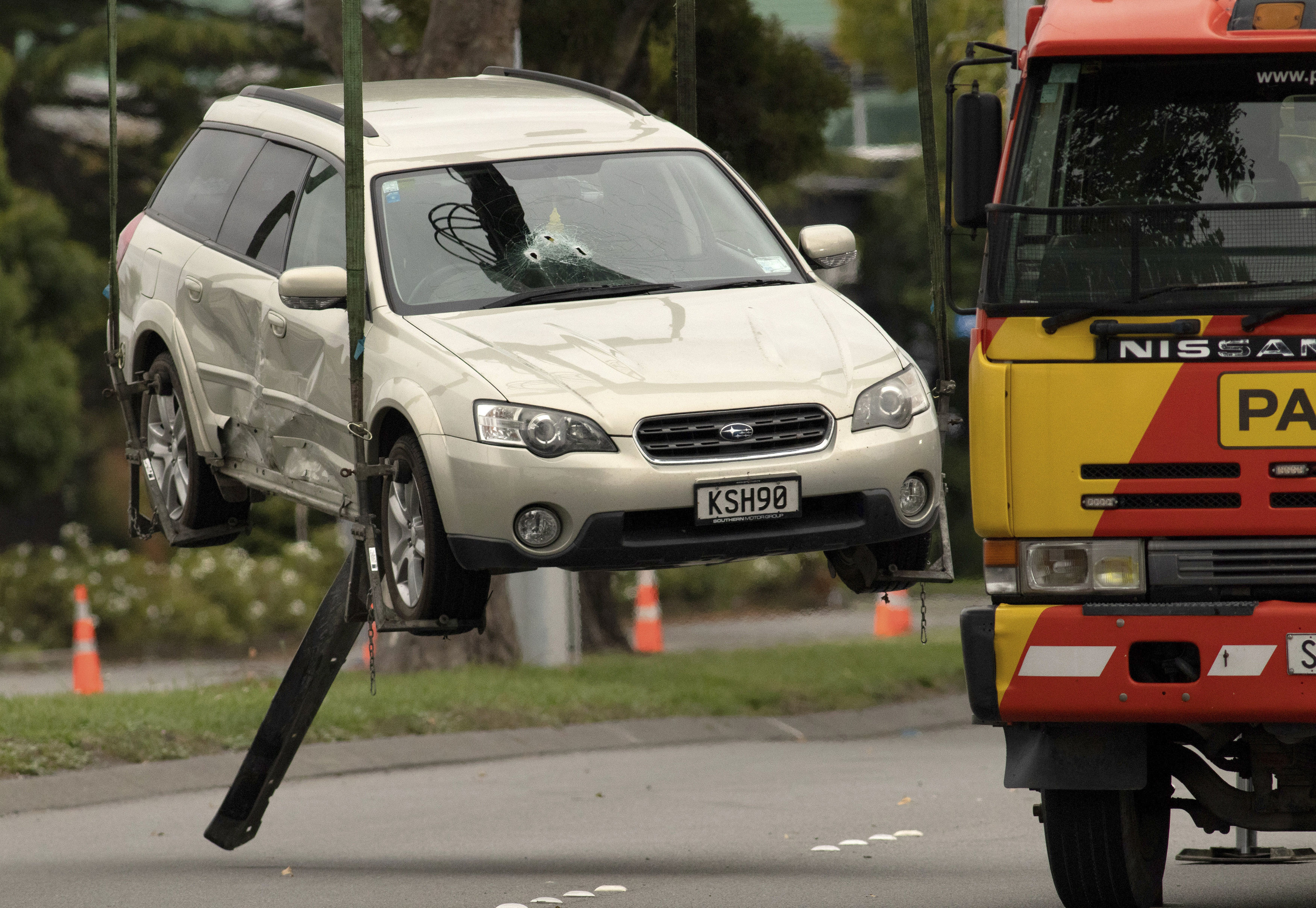 A car thought to be used by the suspect in the Christchurch mosque shootings is lifted onto a tow truck 