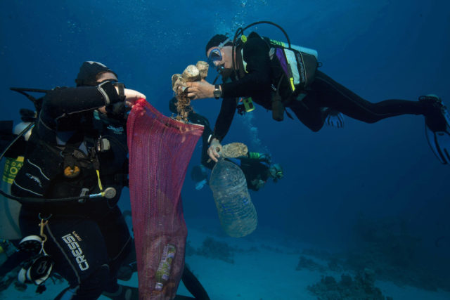 Divers collect plastic and other debris in the sea off Egypt
