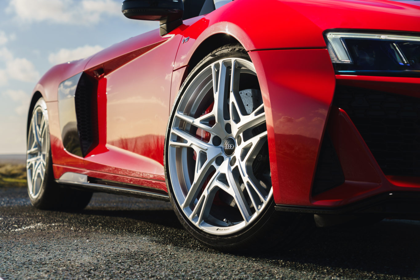 Huge alloy wheels sit in front of ceramic brakes