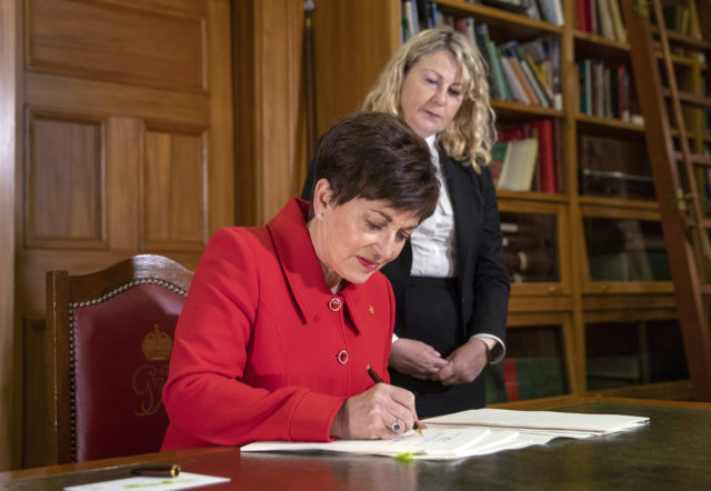 Patsy Reddy signs the legislation