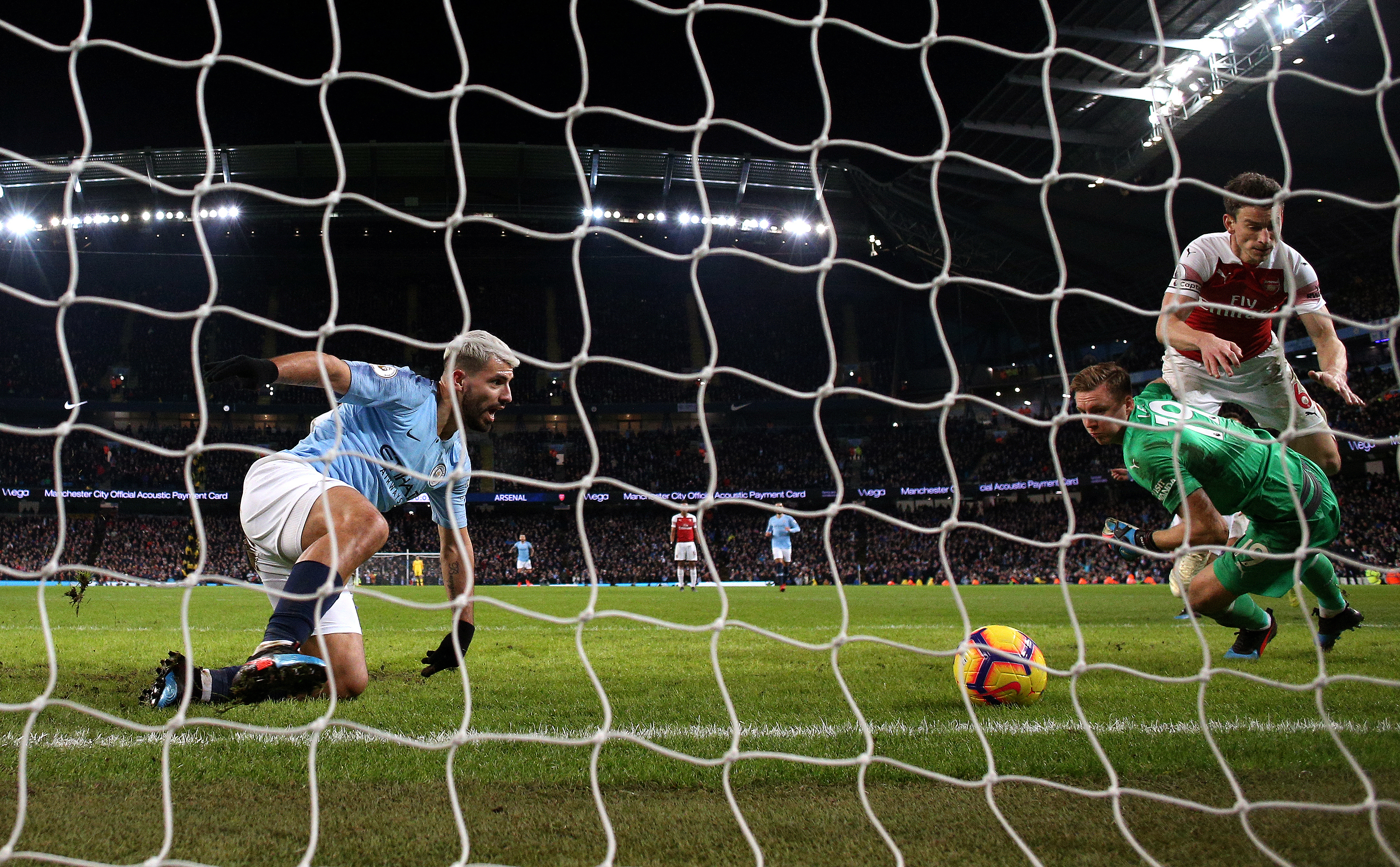 Manchester City's Sergio Aguero (centre) scores his side's third goal of the game during a game against Arsenal