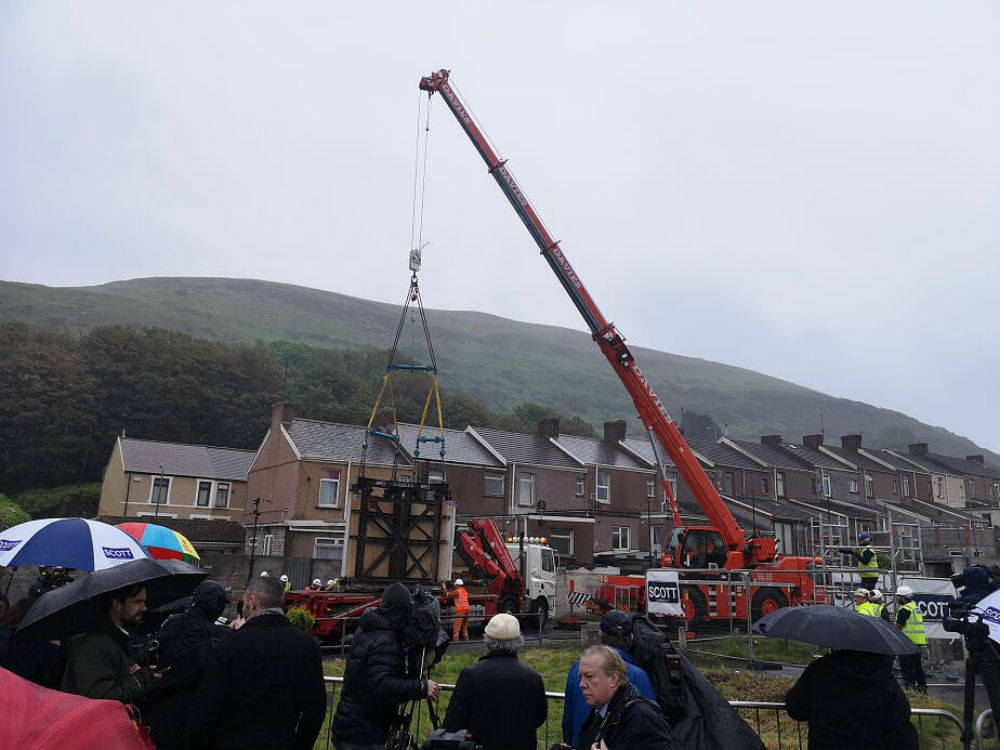 The artwork being lifted by crane 