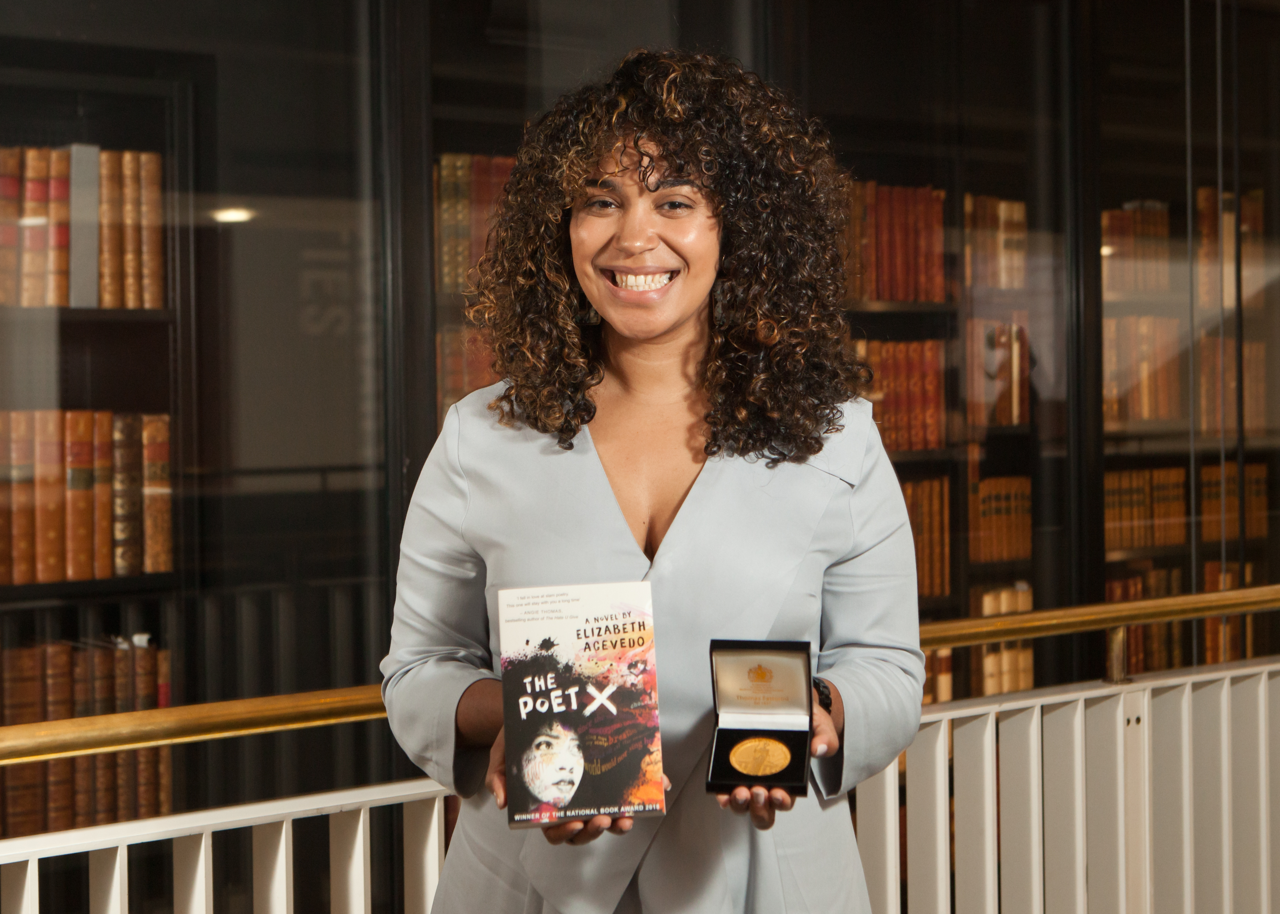 Elizabeth Acevedo with her book The Poet X 